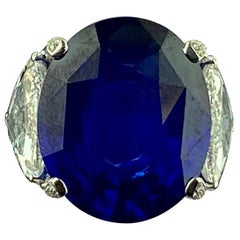 26.08 Carat Oval Shaped Blue Sapphire with 2 GIA Side Trillion Diamonds