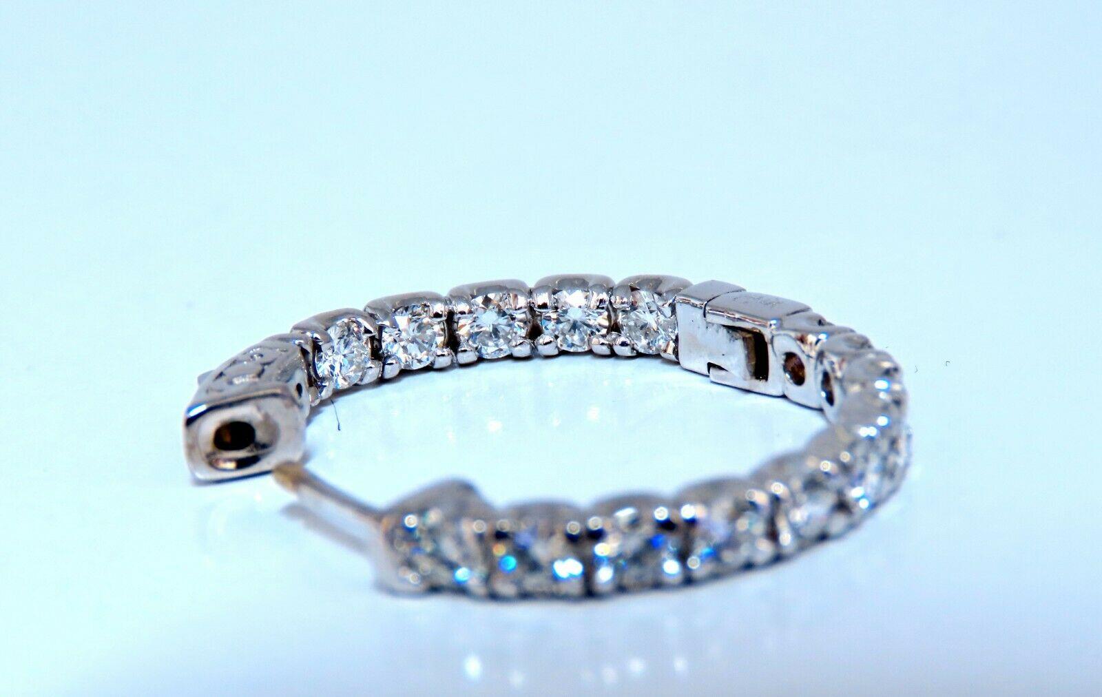 Quarter sized natural diamond hoop earrings.

2.60 carat round brilliant diamonds

G color vs2 clarity

14 karat white gold 8.9 grams

25 mm wide front to back

3.2 mm thick at Diamond row

Push button snap release

$8,000 appraisal certificate to