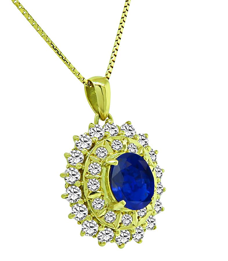 This is an elegant 18k yellow pendant necklace. The pendant is centered with a lovely oval cut sapphire that weighs approximately 2.60ct. The center stone is accentuated by sparkling round cut diamonds that weigh approximately 2.38ct. The color of