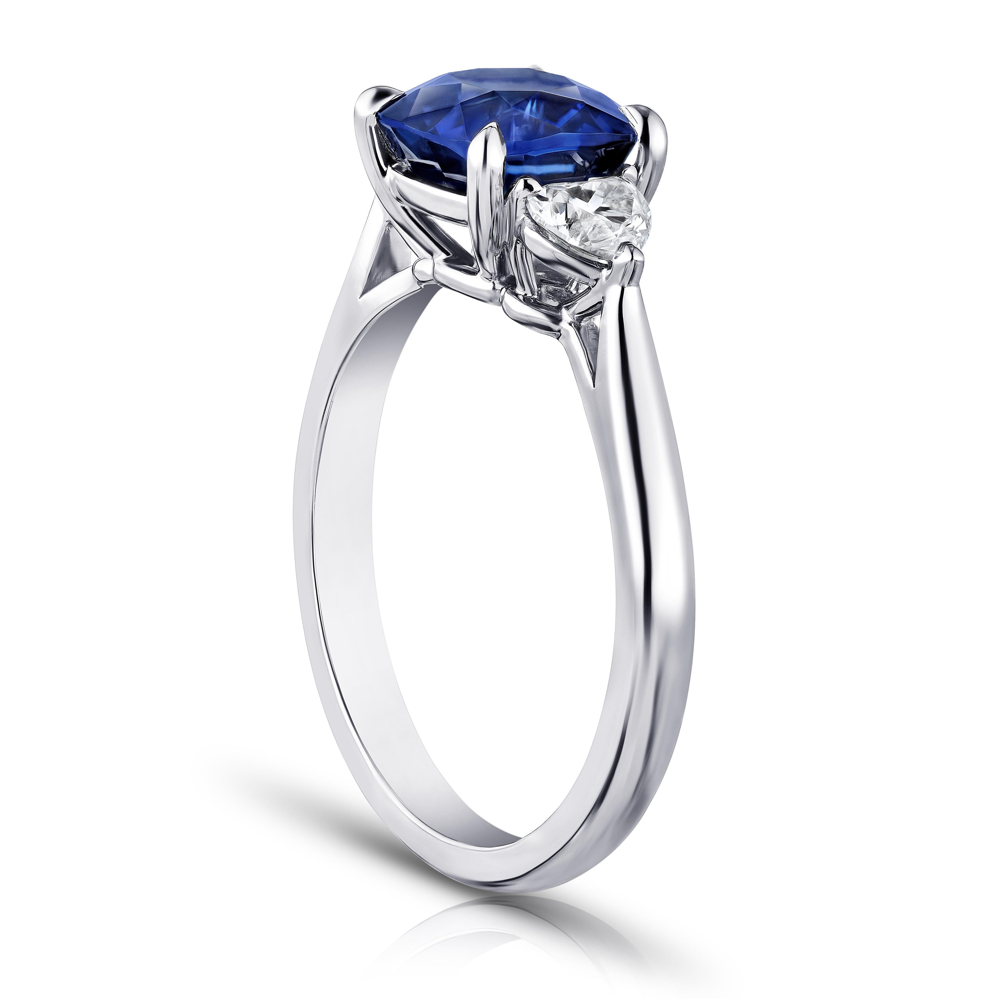2.61 carat cushion blue sapphire with heart shape diamonds .49 carats set in a platinum ring. Ring is currently a size 7. We offer free resizing to your finger size. 
