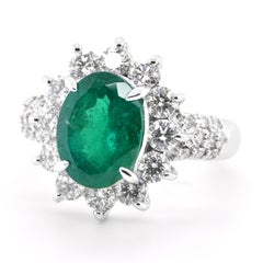 2.61 Carat Natural Oval-Cut Emerald and Diamond Halo Ring Set in Platinum