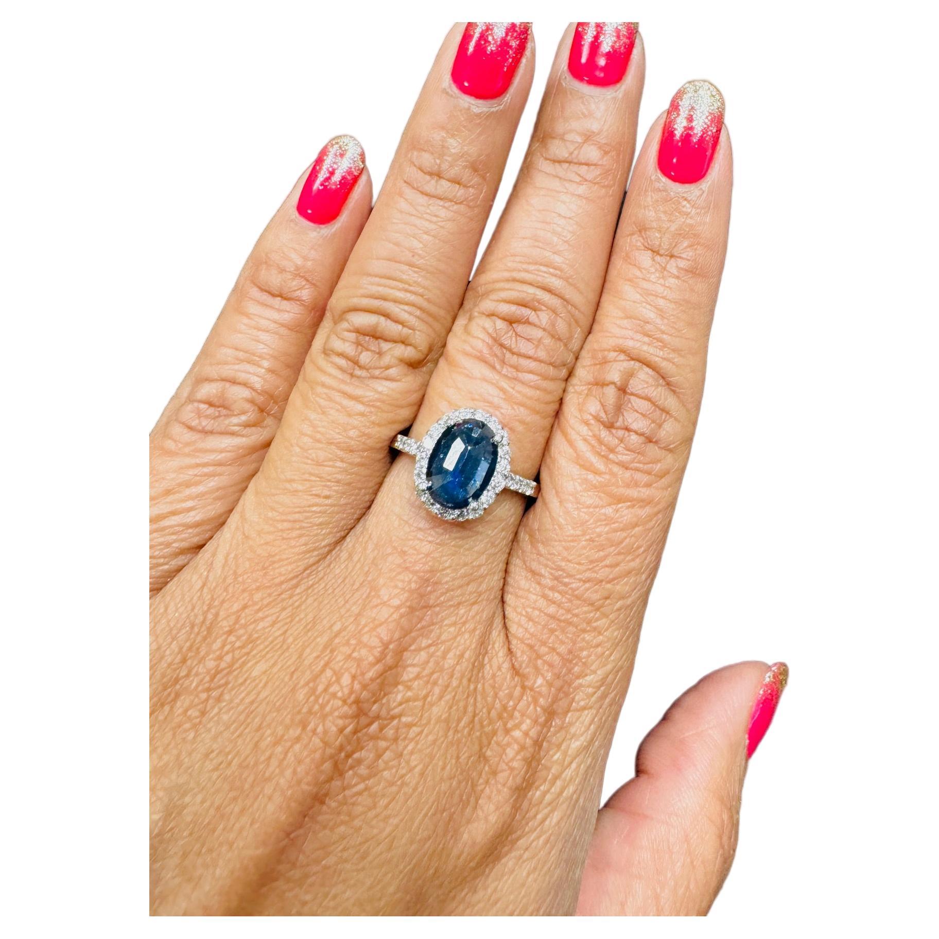 Gorgeous 2.61 Carat Sapphire and Diamond ring that can easily be worn as a unique Engagement ring!  

The Deep Midnight Blue Oval~Rose Cut Sapphire weighs 2.14 Carats and is surrounded by 26 Round Cut Diamonds that weigh 0.47 Carats.  The total