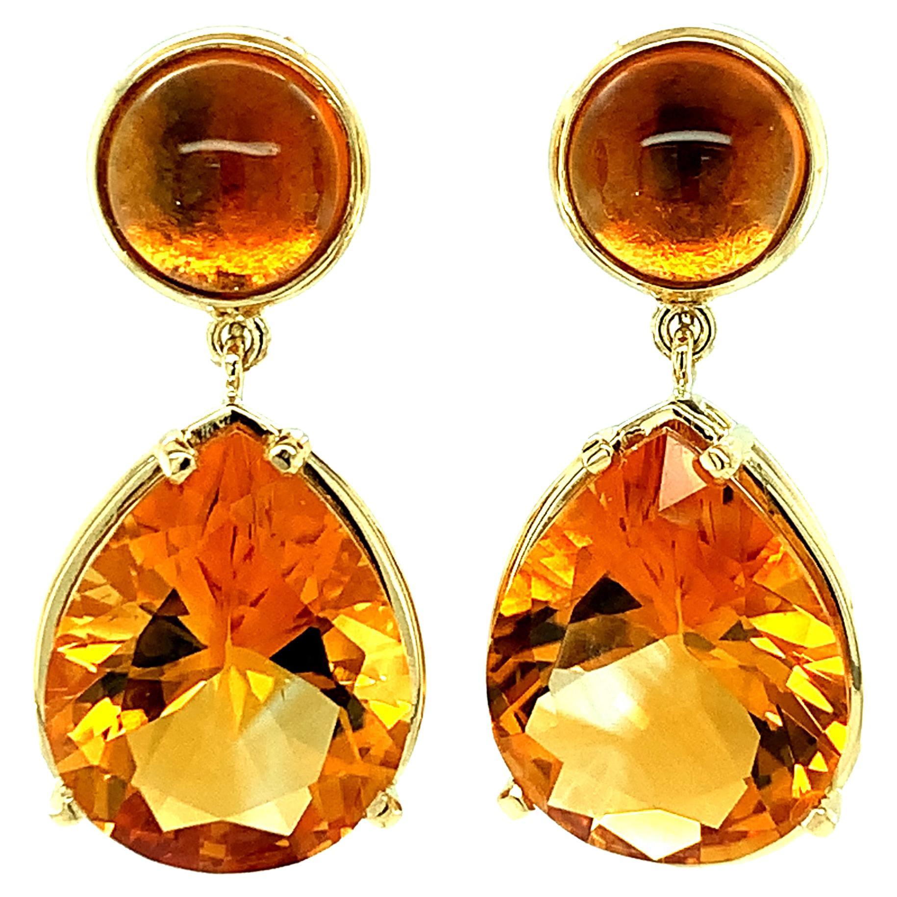 These warm-colored citrine earrings are like giant rays of golden sunshine! Round cabochon citrines with gorgeous deep amber color are bezel set in 18k yellow gold and sit comfortably on the ear lobe, while large, faceted pear-shaped citrines dangle