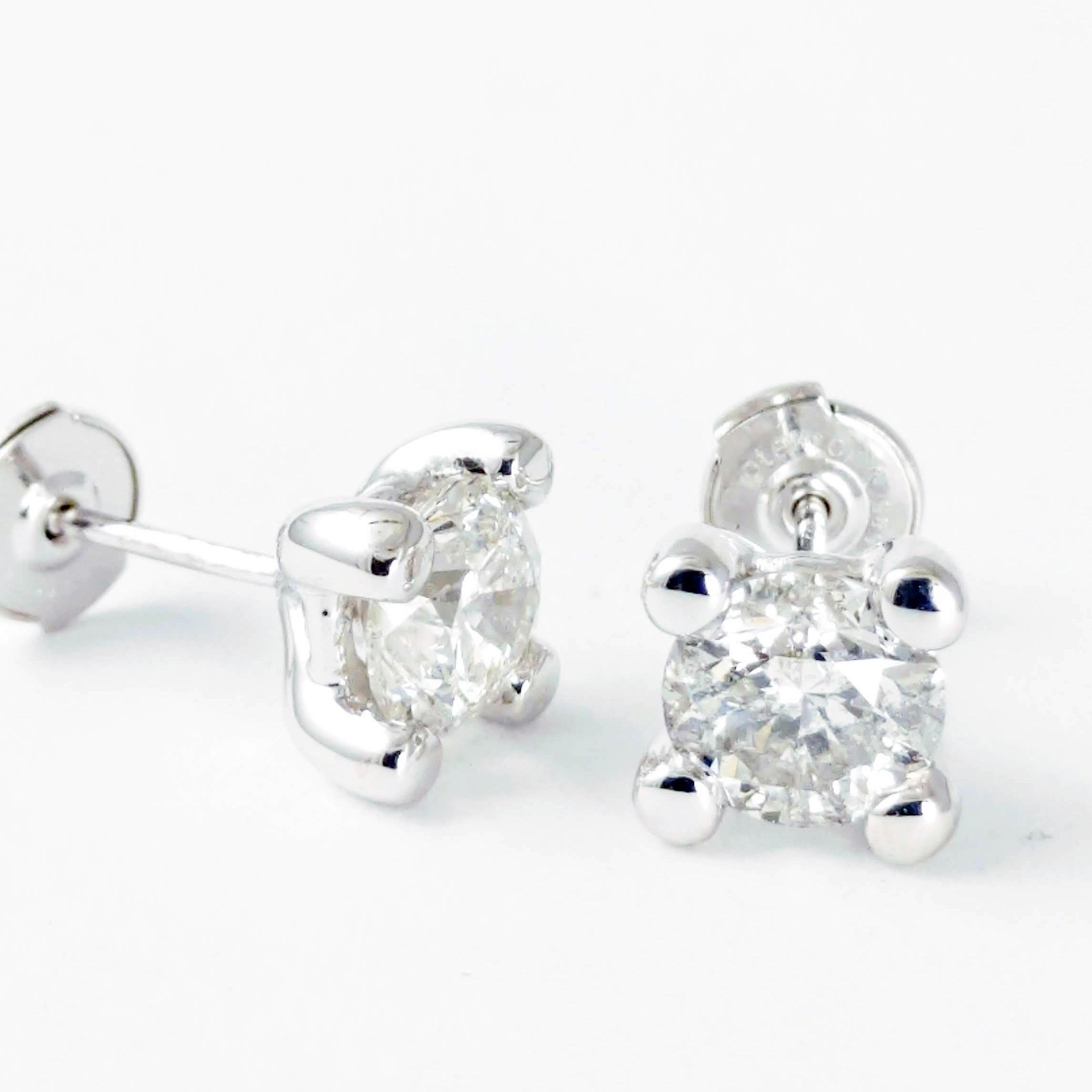 These earrings update a timeless and classic look. The casual stud earrings are set into a custom-made heavy four-prong style mounting made of 14k white gold. The studs feature two round GIA certified brilliant cut diamonds, 2.61 ctw., that are