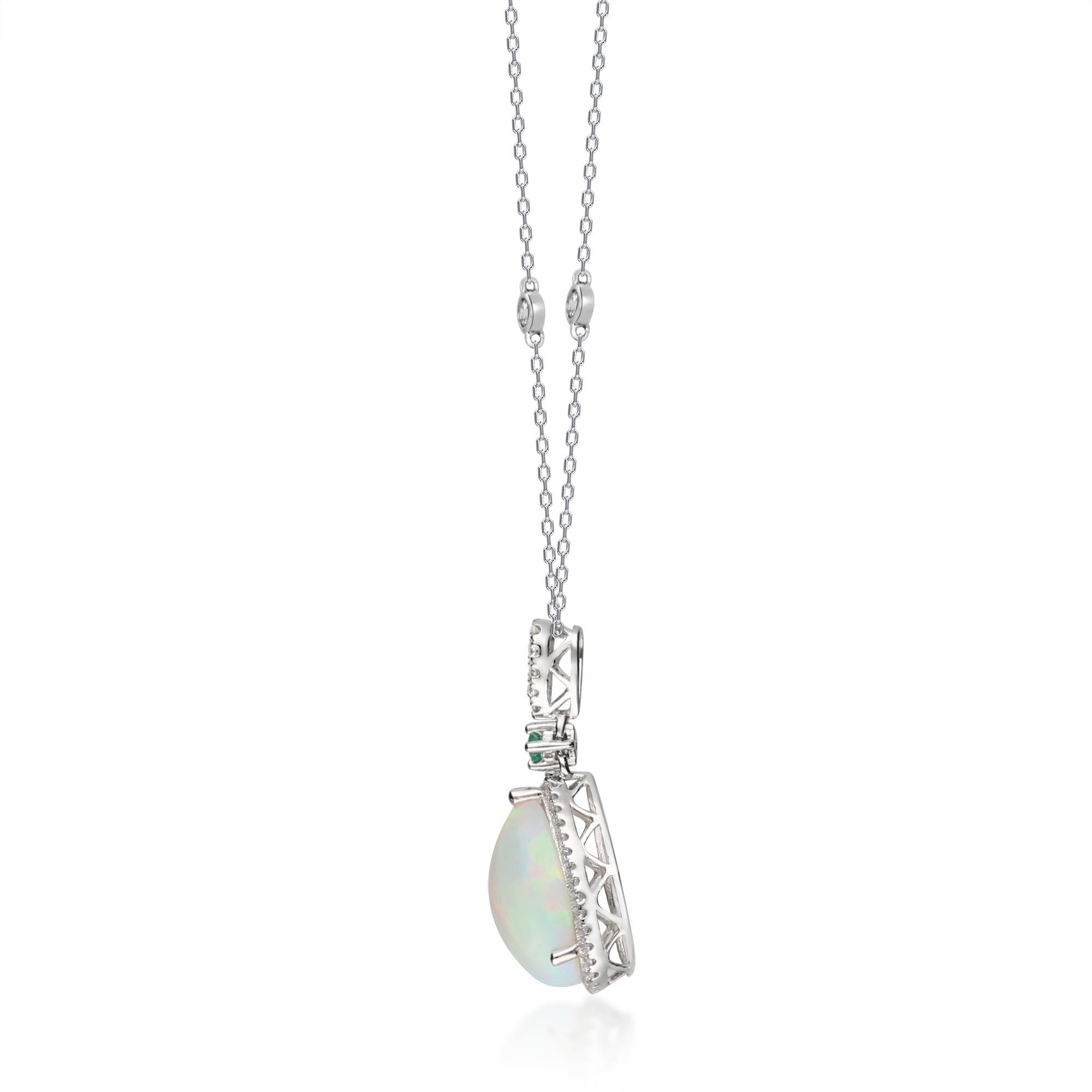 This magnificent opal Pendant is crafted in 14-karat white gold and features a pear shaped 2.62 carat Ethiopian Opal, 0.05 carat Round cut emerald and 49 Round Diamonds in GH- I1 quality with 0.37 ct. in a prong-setting. 
This pendant comes with 18