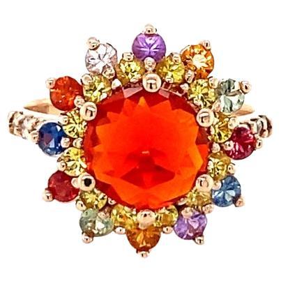 Super gorgeous and uniquely designed 2.62 Carat Fire Opal and Multi-Colored Sapphire and Diamond Rose Gold Cocktail Ring!

Item Specs:
Natural Fire Opal (Round Cut) = 1.16 Carats
12 Natural Multi-Colored Sapphires (Round Cut) = 0.80 Carats 
12
