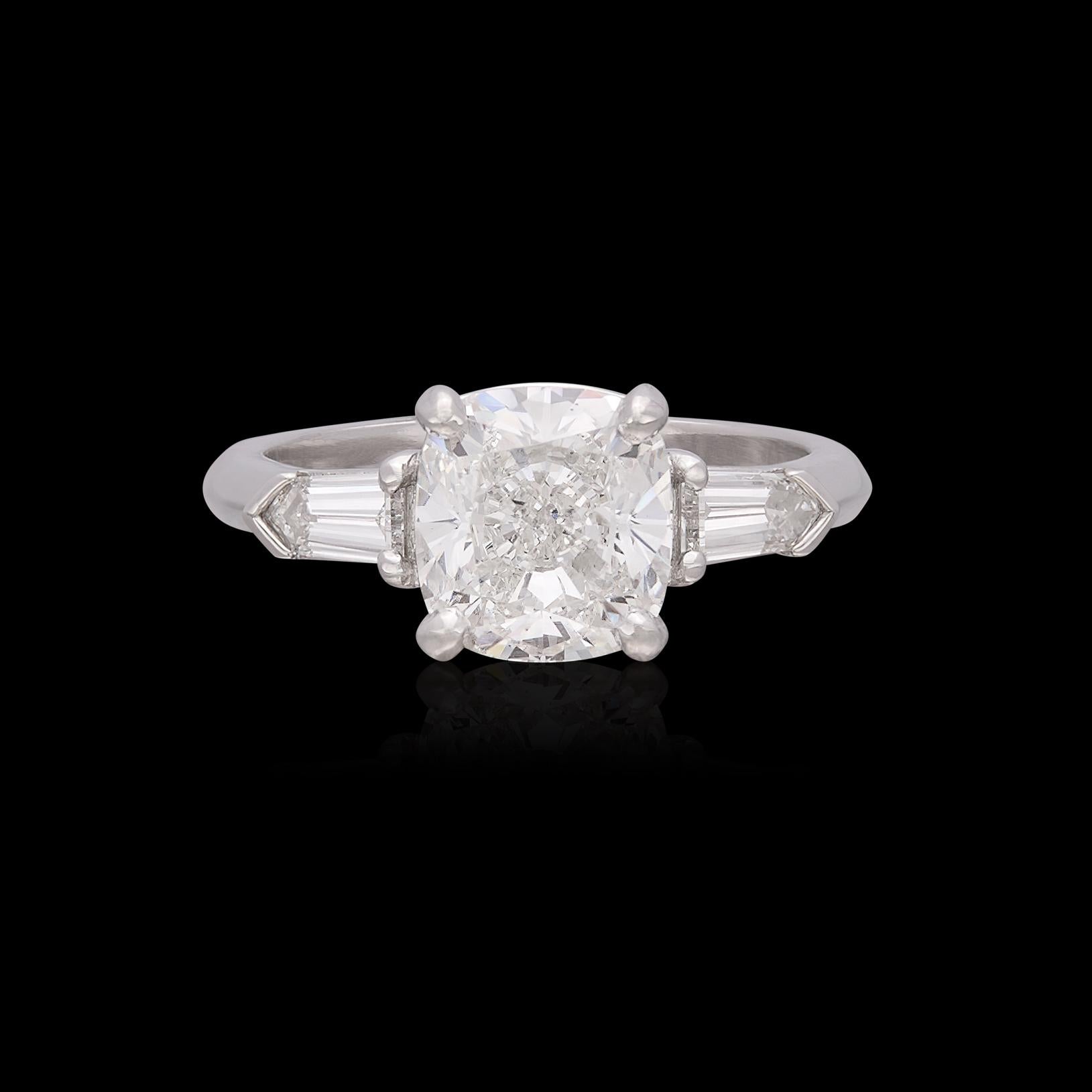 An extraordinary engagement ring meant for an extraordinary bride. This platinum beauty features a 2.62 carat Cushion Cut diamond flanked by a Bullet Cut diamond expertly set on either side for 0.46 carats. The gorgeous cushion cut diamond has been
