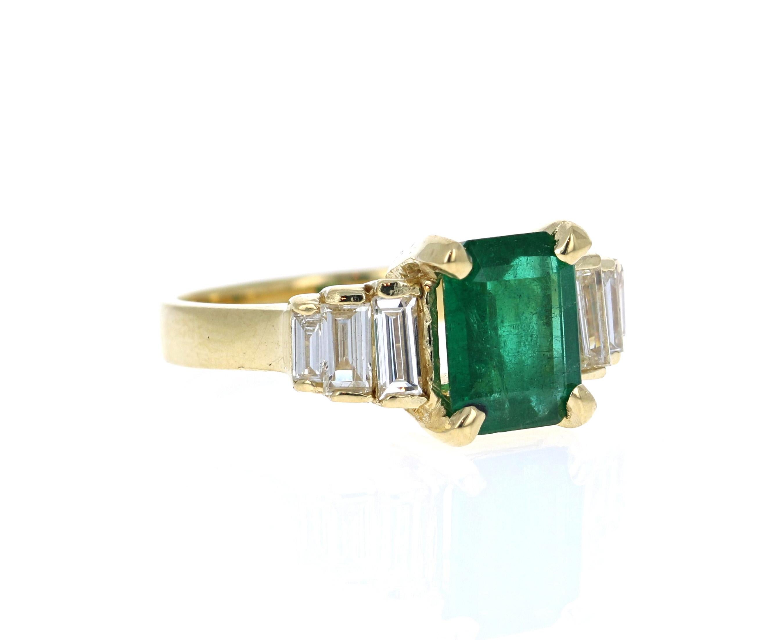 This gorgeous ring has a large and deep green Emerald Cut Emerald that is set in the center of the ring that weighs 1.95 Carats.  The Emerald is surrounded by 6 Baguette Cut Diamonds that weigh 0.68 Carats. (Clarity: VS, Color: H). The total carat