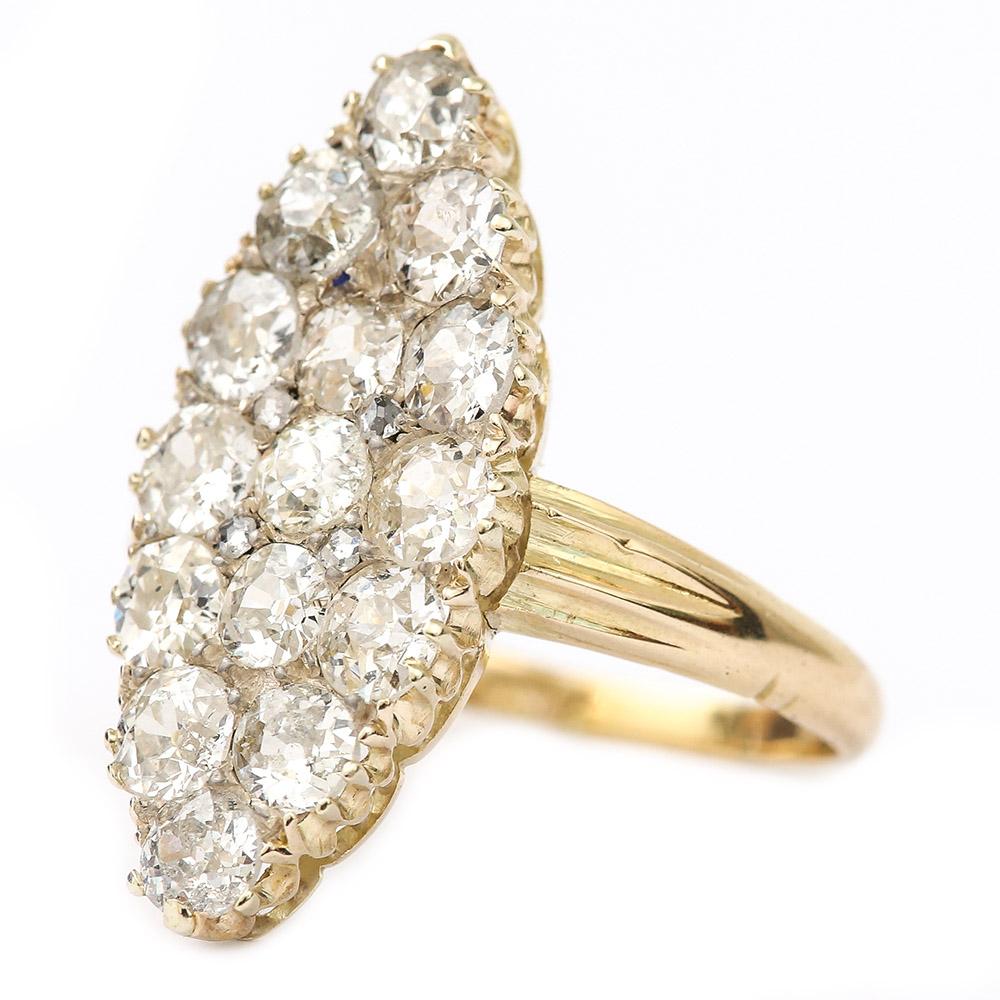 A super example of the marquise* or navette shaped ring much favoured by the Victorians. Modelled in 18 karat yellow gold and silver set antique diamond ring is set with 15 Old European Cut diamonds. The head of the ring is 1” long. Each claw set