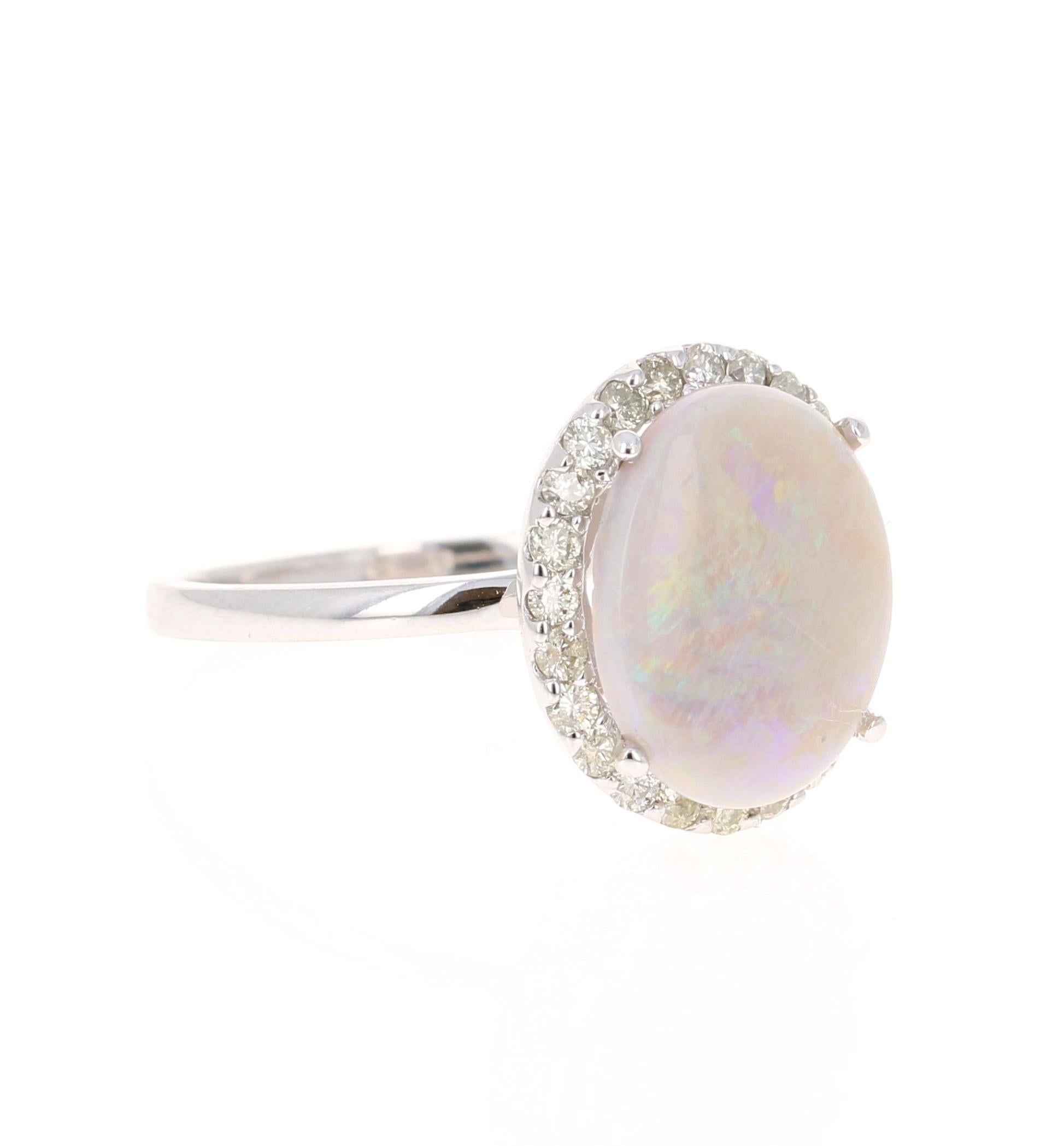 This ring has a simple 2.23 Carat Opal and has 24 Round Cut Diamonds that weigh 0.40 Carats. The total carat weight of the ring is 2.63 Carats. 

The Opal measures at  11 mm x 13 mm (width x length) 

The Opal is semi transparent and has flashes of