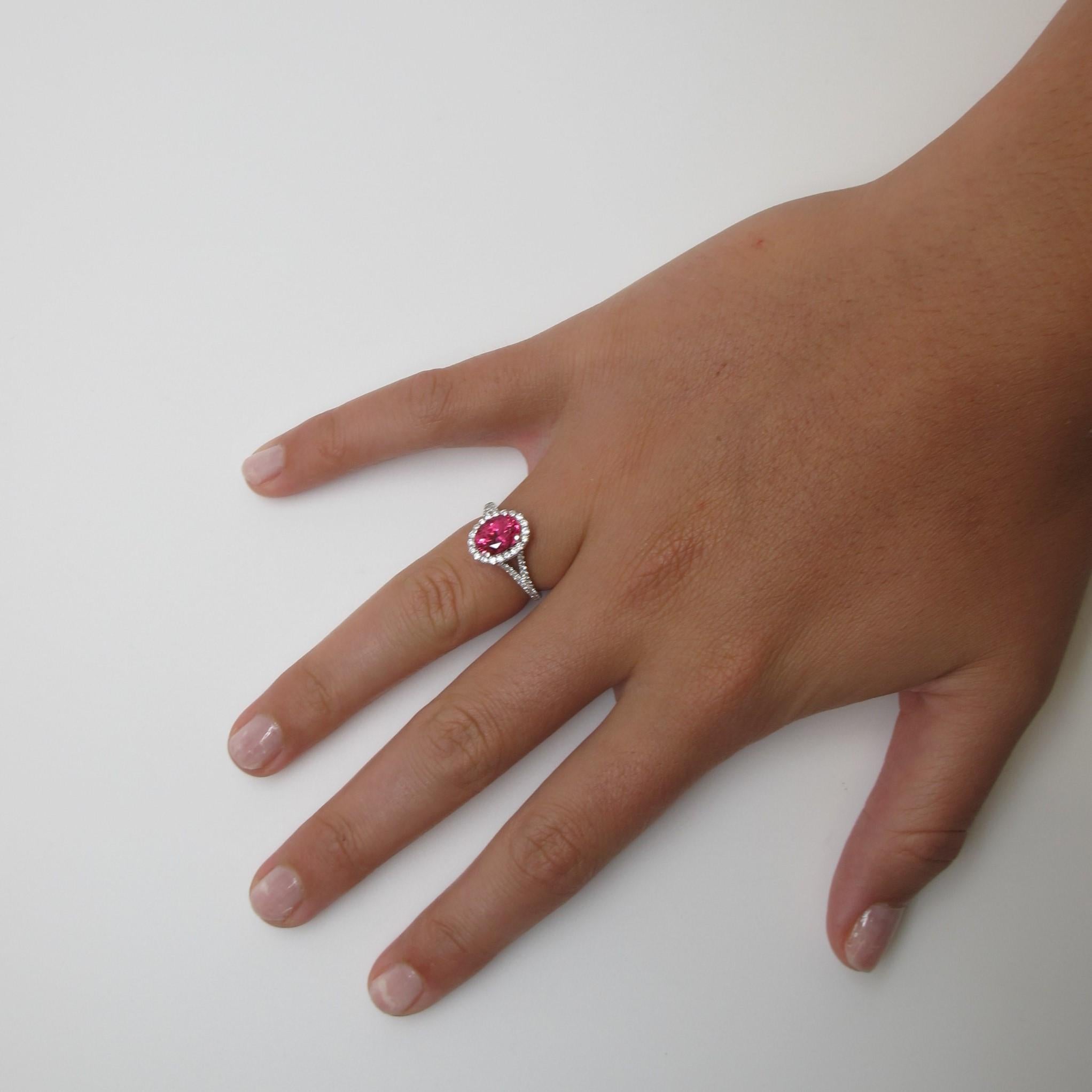 This fiery fuchsia colored spinel is both bright and bold! Perfect for any occasion, the spinel measures 8.53x6.57x4.73mm (2.63 carats) and is set with 74 fine quality brilliant cut diamonds (0.64 carats total weight). It is a 