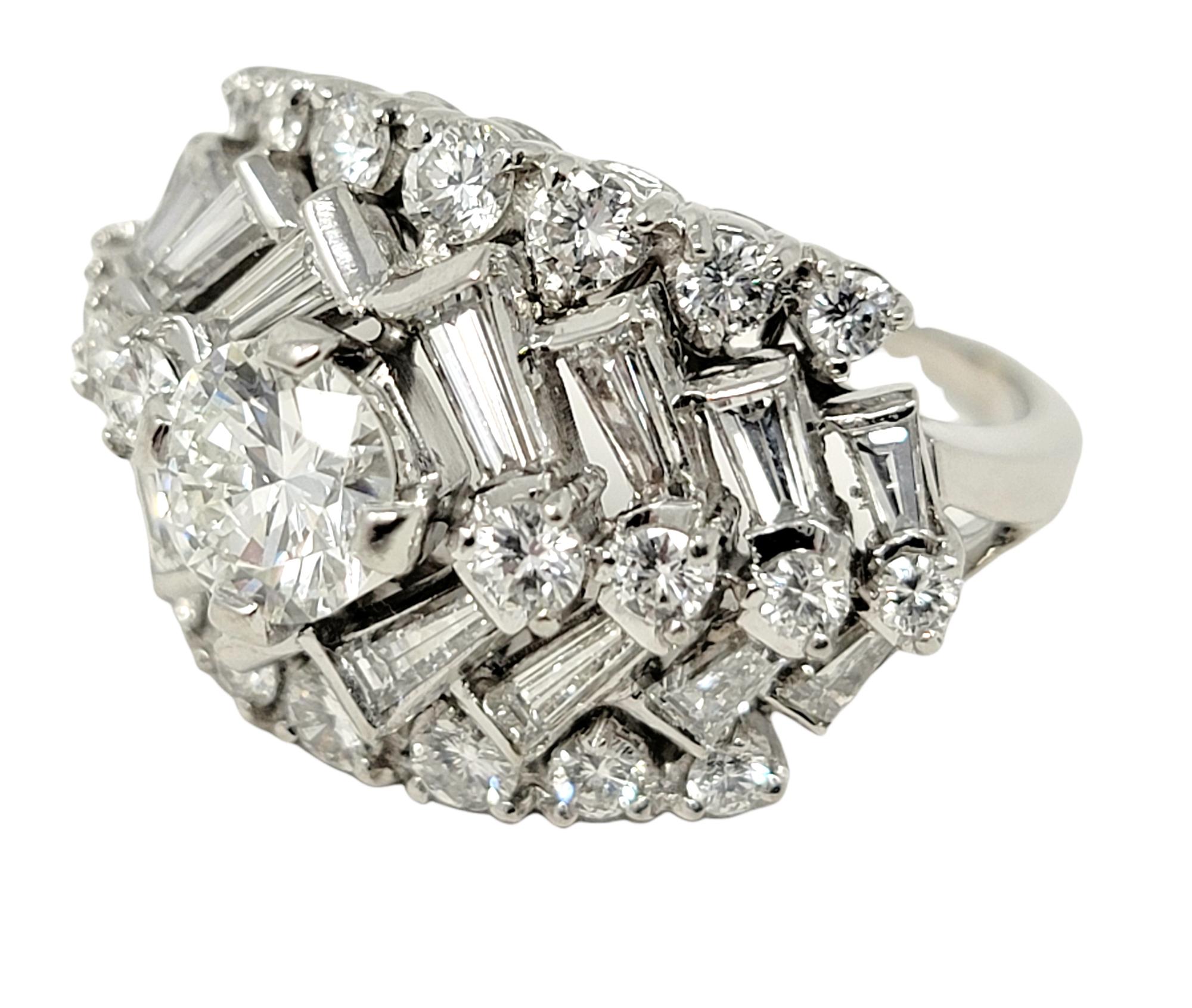 Ring size: 7

This stunningly sparkly chevron patterned diamond band ring will absolutely take your breath away. An incredible, ice white round brilliant .75 carat center stone is surrounded by a series of stacked baguette and round diamonds,