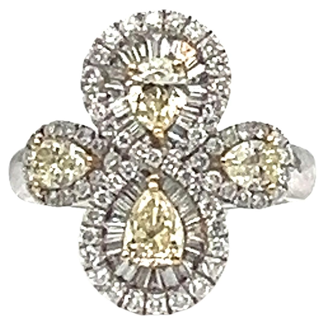 This stunning ring features  natural pear-shaped yellow diamonds as the main stones and 103 natural diamonds as secondary stones. The diamonds are set in 18k white gold, giving the ring a beautiful and elegant look. The ring can be sized to fit and