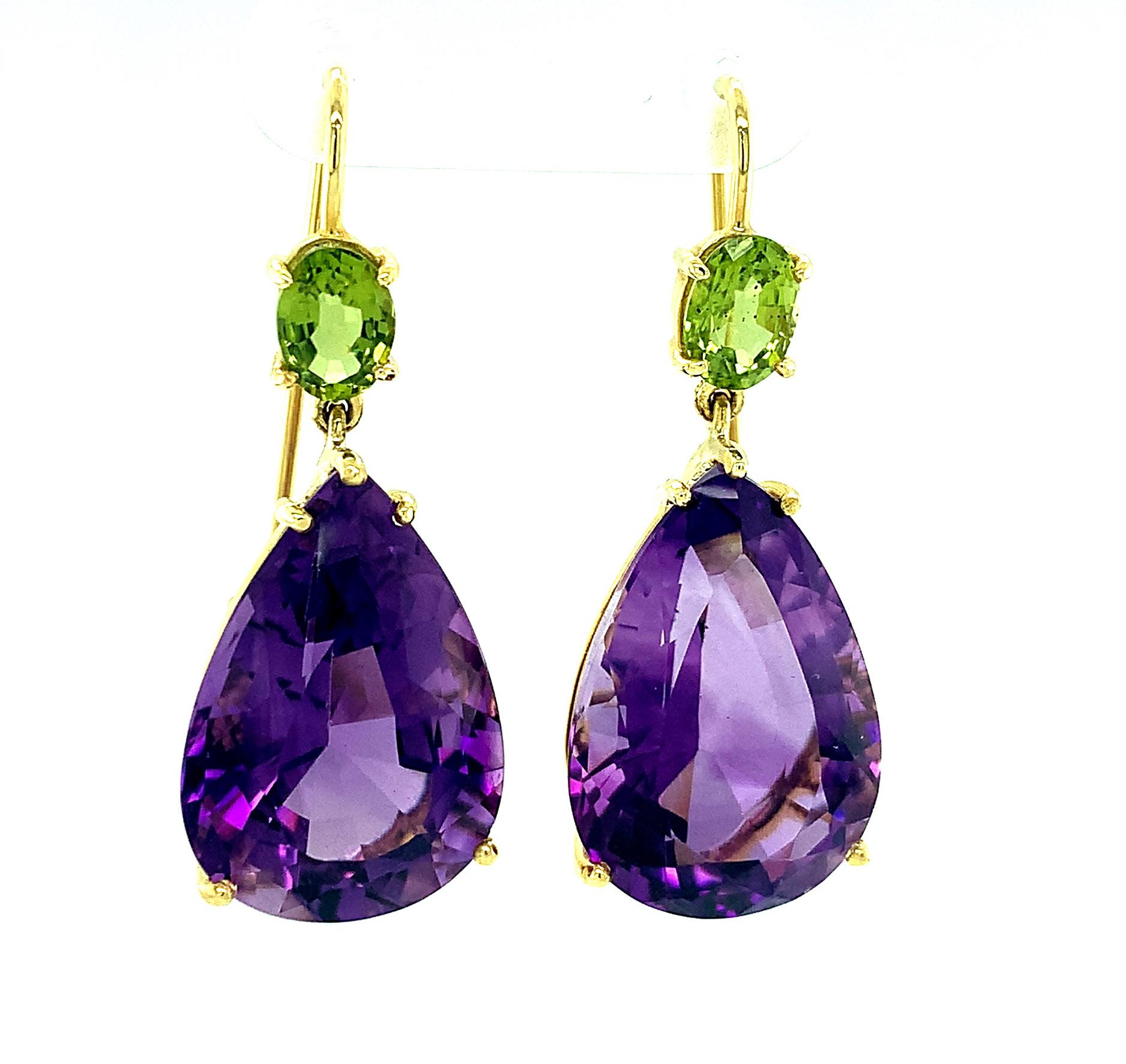 These big, beautiful drop earrings are bold and happy with the combination of huge, violet-purple amethysts and vibrant lime-green peridots. Dangling from 18k yellow gold wires, these fun are comfortable and definite attention-grabbers! Treat