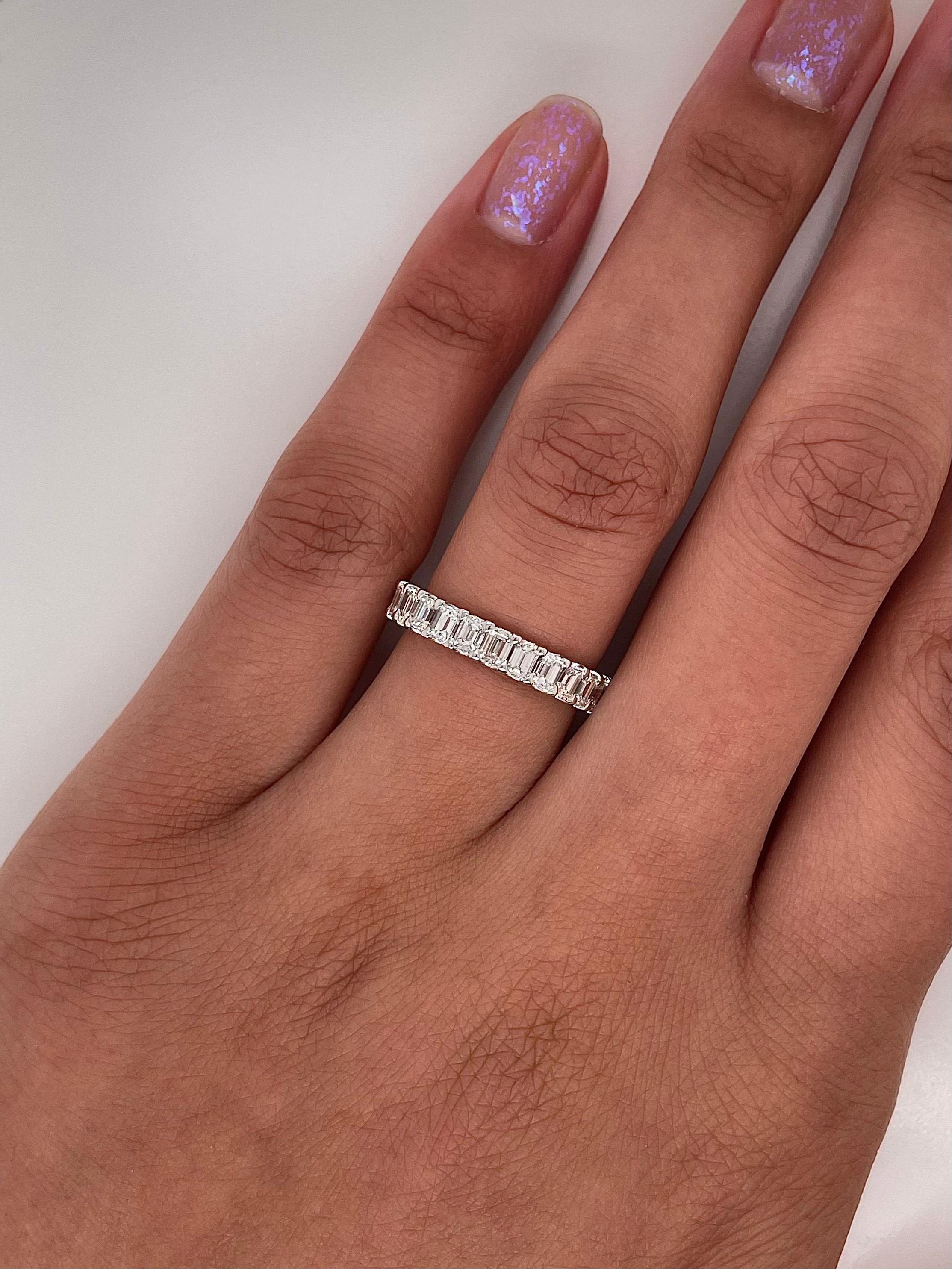 Ladies diamond Eternity band carries 2.63 total Carats emerald cut diamonds placed in platinum.

Size: 6.0
Color: G
Clarity: VS1

This shared prong style Eternity band was handmade by our jewelers in New York City.