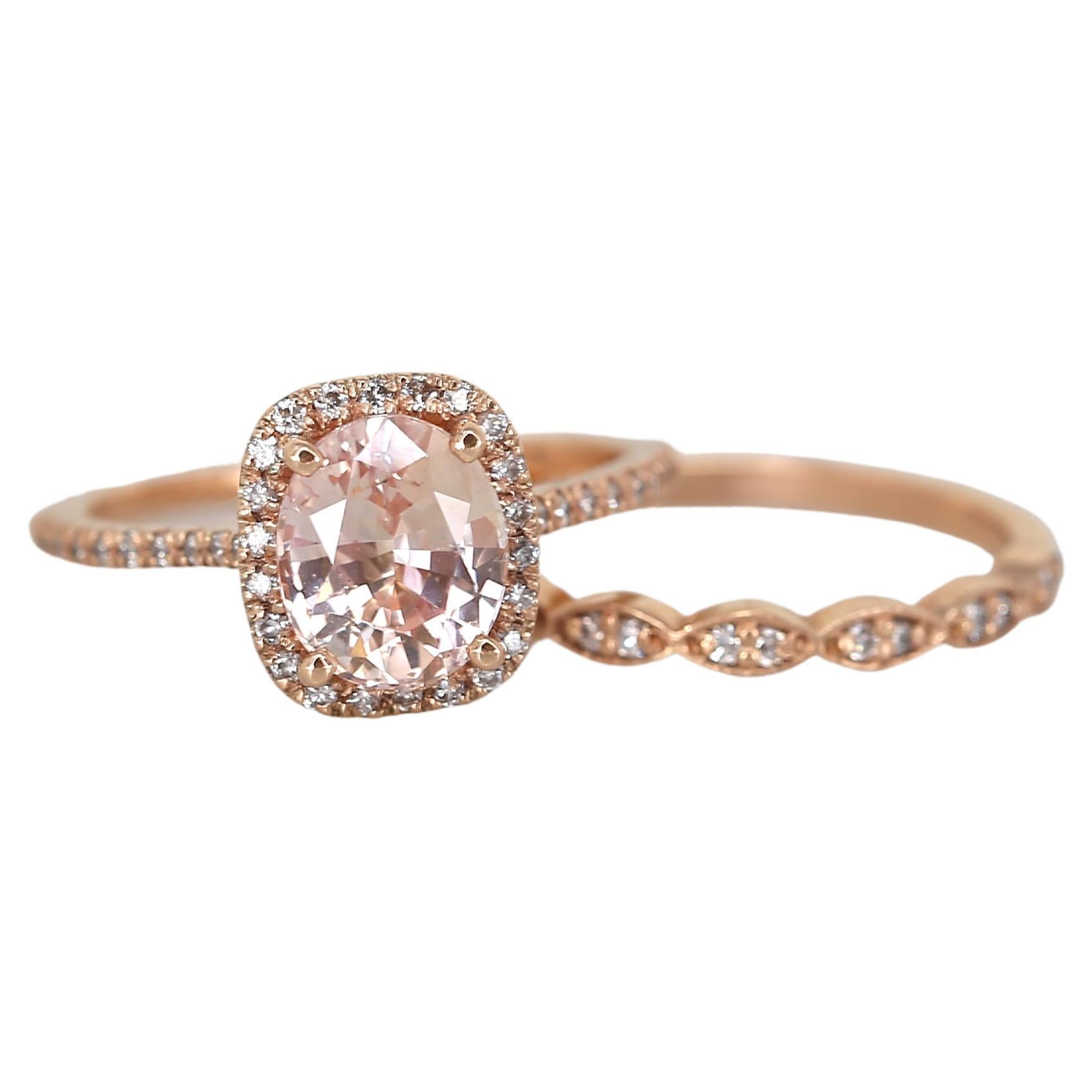 Say hello to an exquisite art deco-inspired bridal set with a unique peach sapphire center stone. Our expert artisans delicately mount pave and shared prong style diamonds, creating a stunning, sparkling design. Experience the perfect blend of
