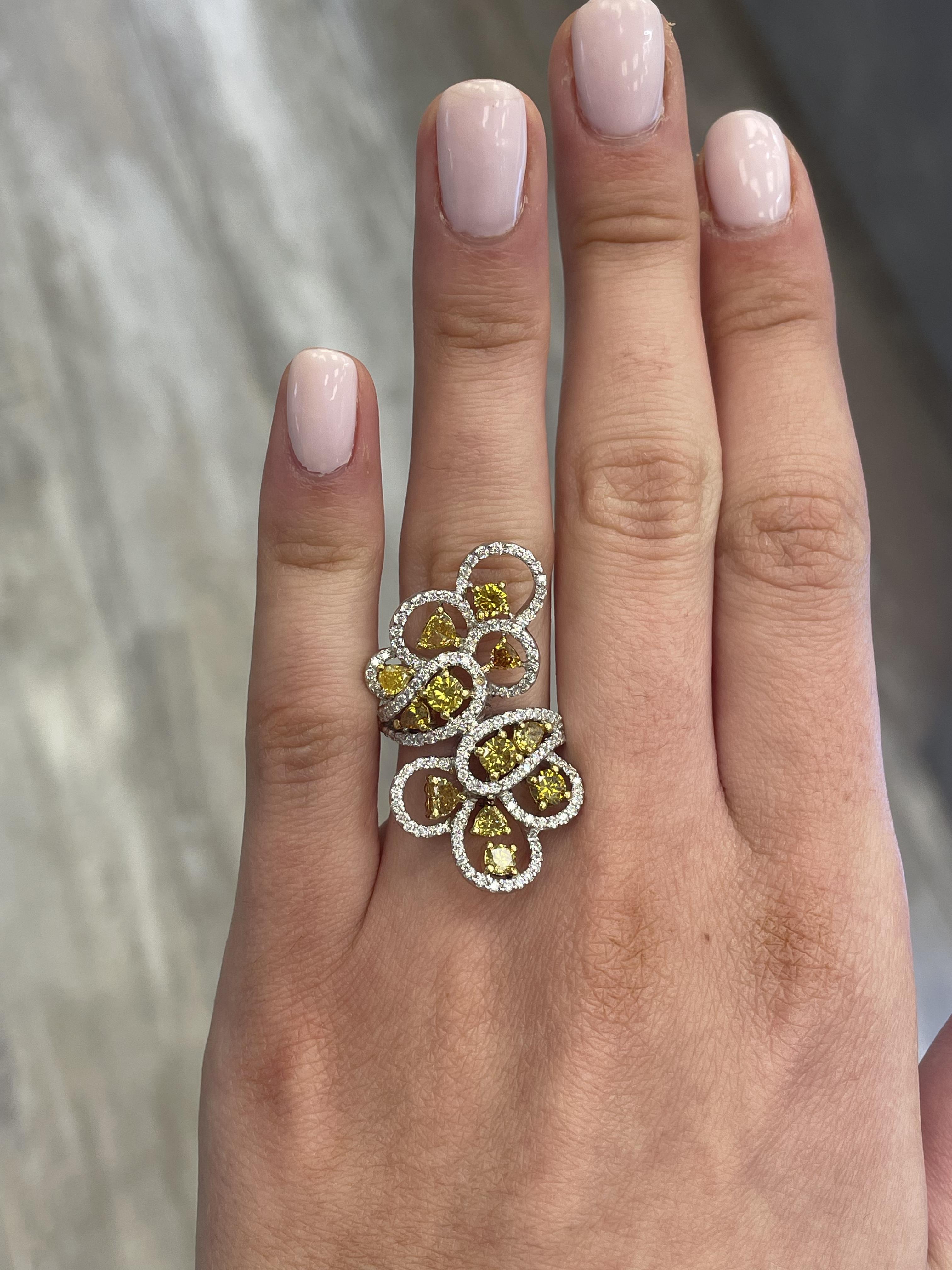 Lovely yellow diamond floral ring.
2.63 carats total diamond weight.
12 mixed diamonds, 1.79 carats. Approximately Fancy Greenish Brownish Yellow color diamonds SI clarity. Complimented by 143 round cut diamonds, 0.84 carats total. Approximately G/H