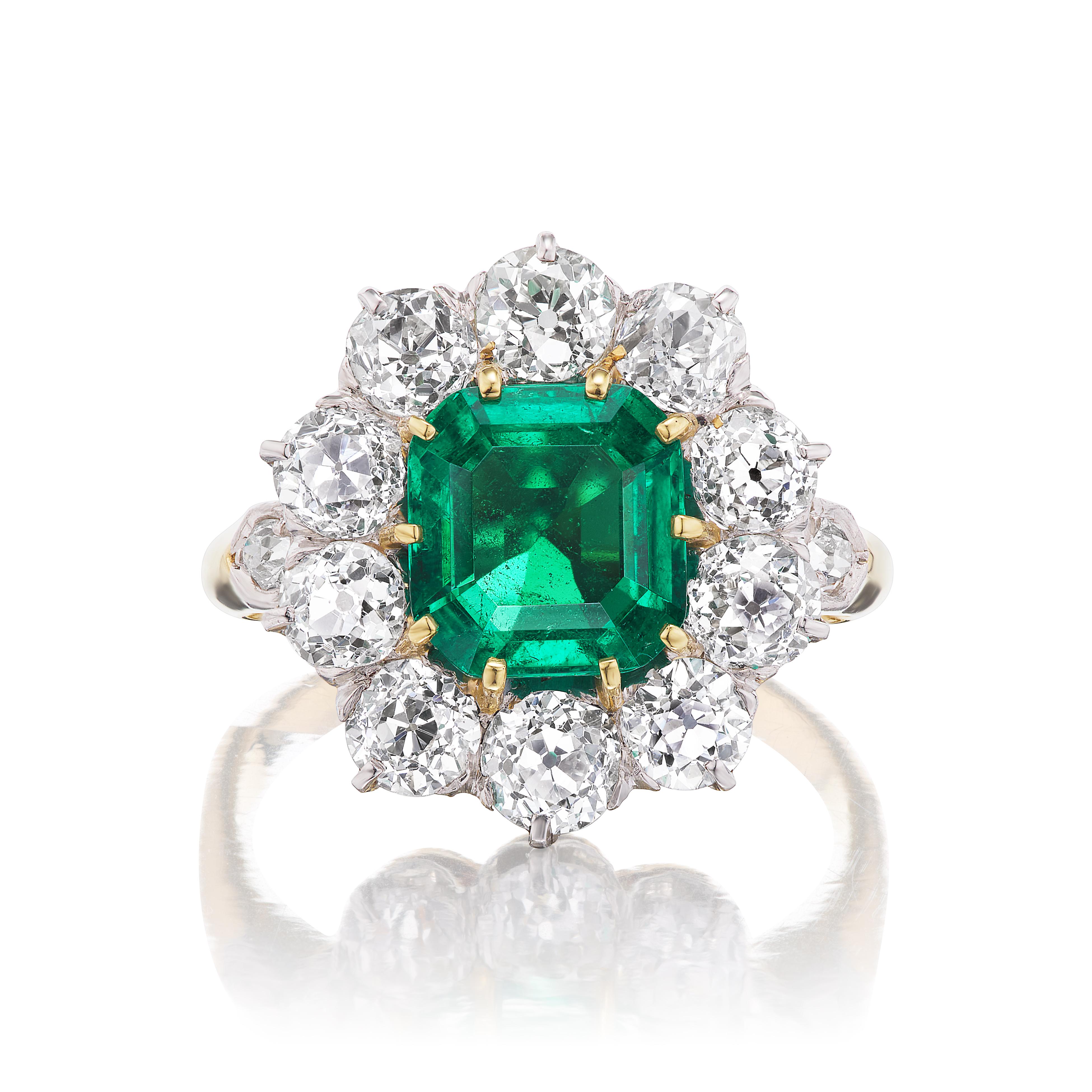 This charming antique ring centers around a 2.64 carat colombian emerald of exceptional clarity and rich color. The fine crystal is accompanied by a certificate from AGL stating the emerald exhibits minor traditional clarity enhancement. The ring is