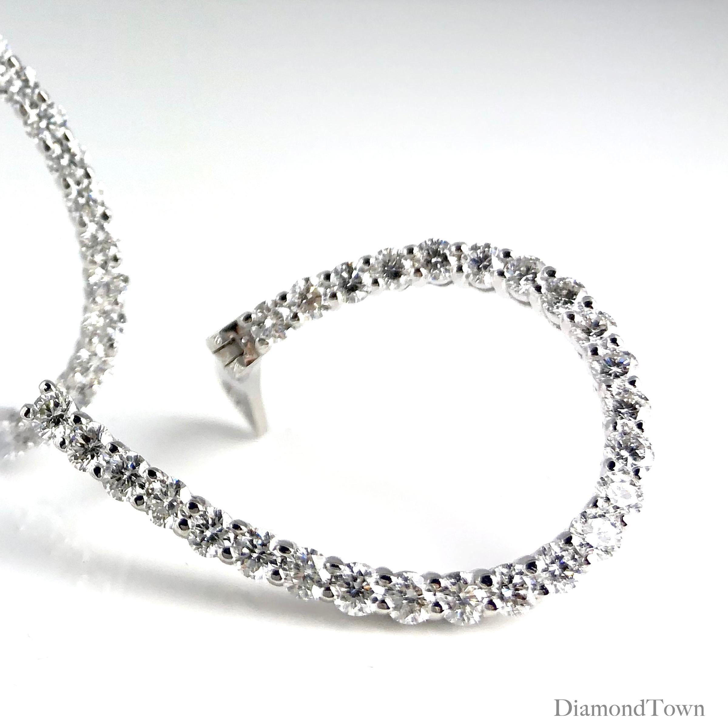 These sparkling hoop earrings shine with 2.64 carats round diamonds set in a playful inside/outside three dimensional teardrop swirl shape, adorning all the front-facing surfaces. Set in 14k White Gold. A suitable bridal accompaniment, or for the