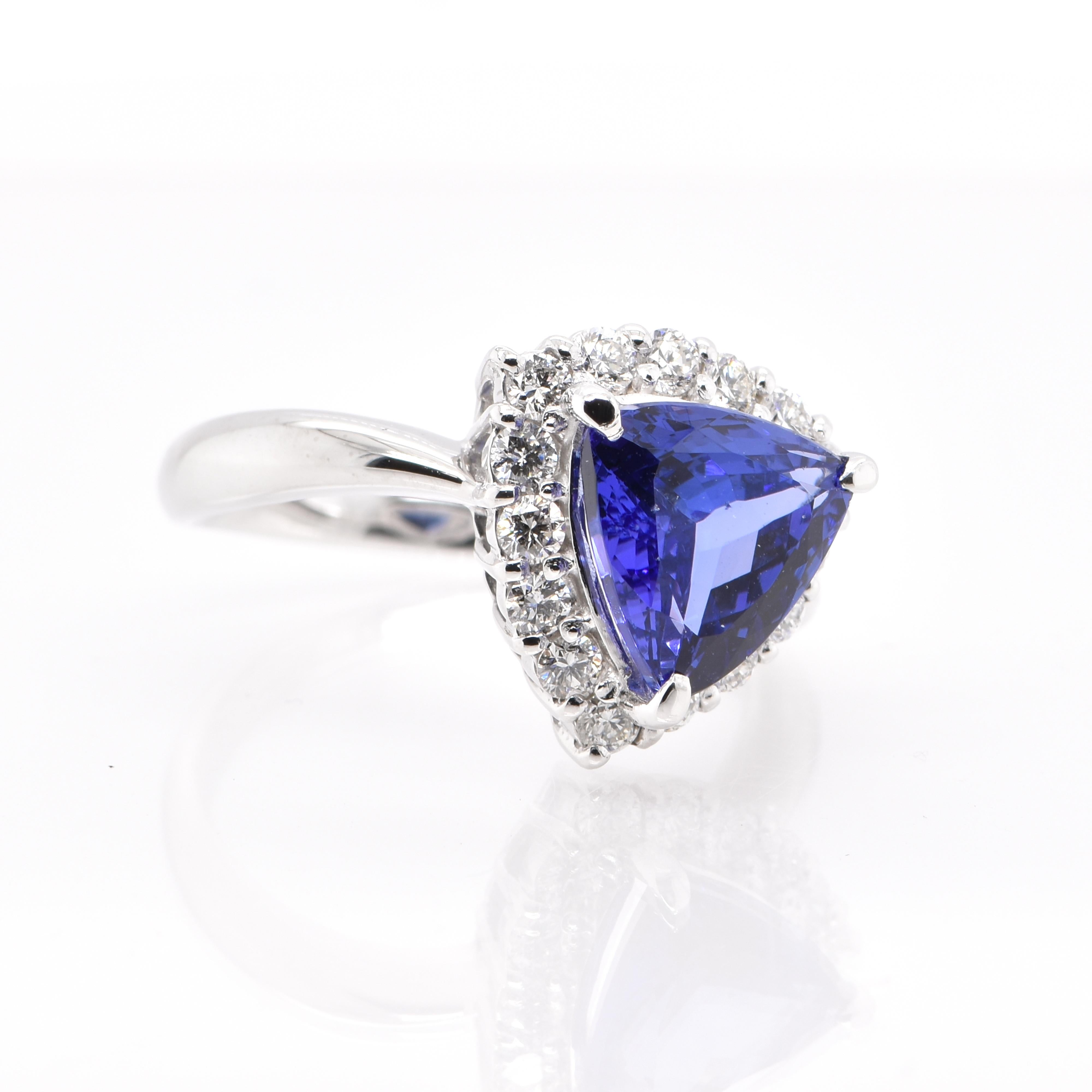 A beautiful Halo Ring featuring a 2.64 Carat, Natural, Trillion-Cut Tanzanite and 0.53 Carats of Diamond Accents set in Platinum. Tanzanite's name was given by Tiffany and Co after its only known source: Tanzania. Tanzanite displays beautiful