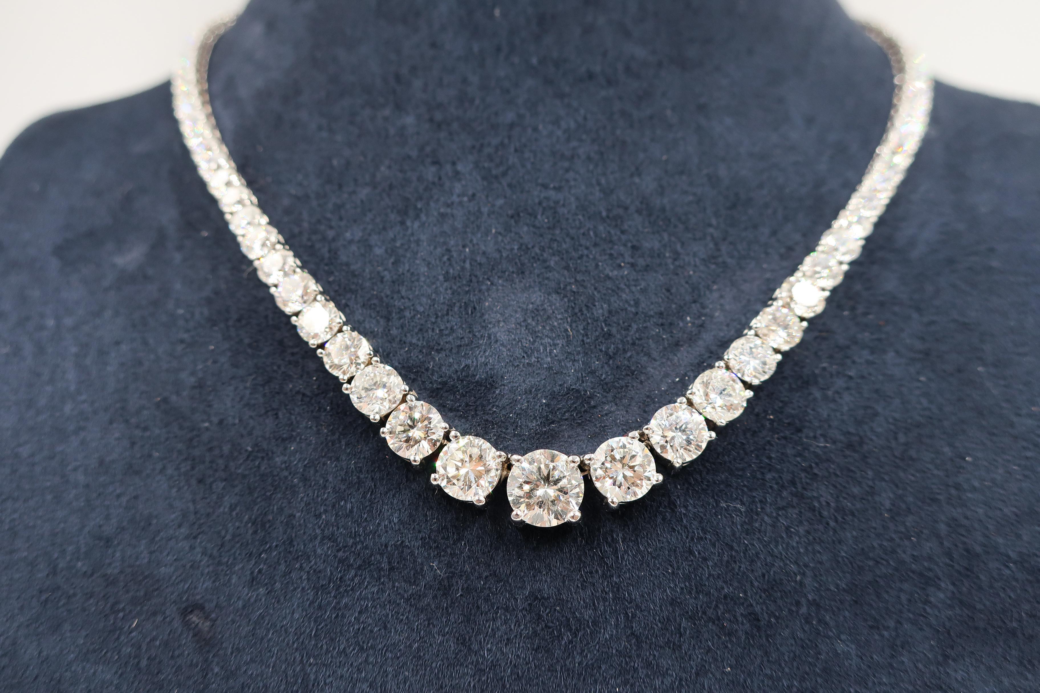 This beautiful graduated in size riviera style diamond necklace features a total of 104 round brilliant cut diamonds weighing a total of 26.46 carats, set in 18K white gold. Diamond Color ranges from D-F, SI clarity

Style available in different