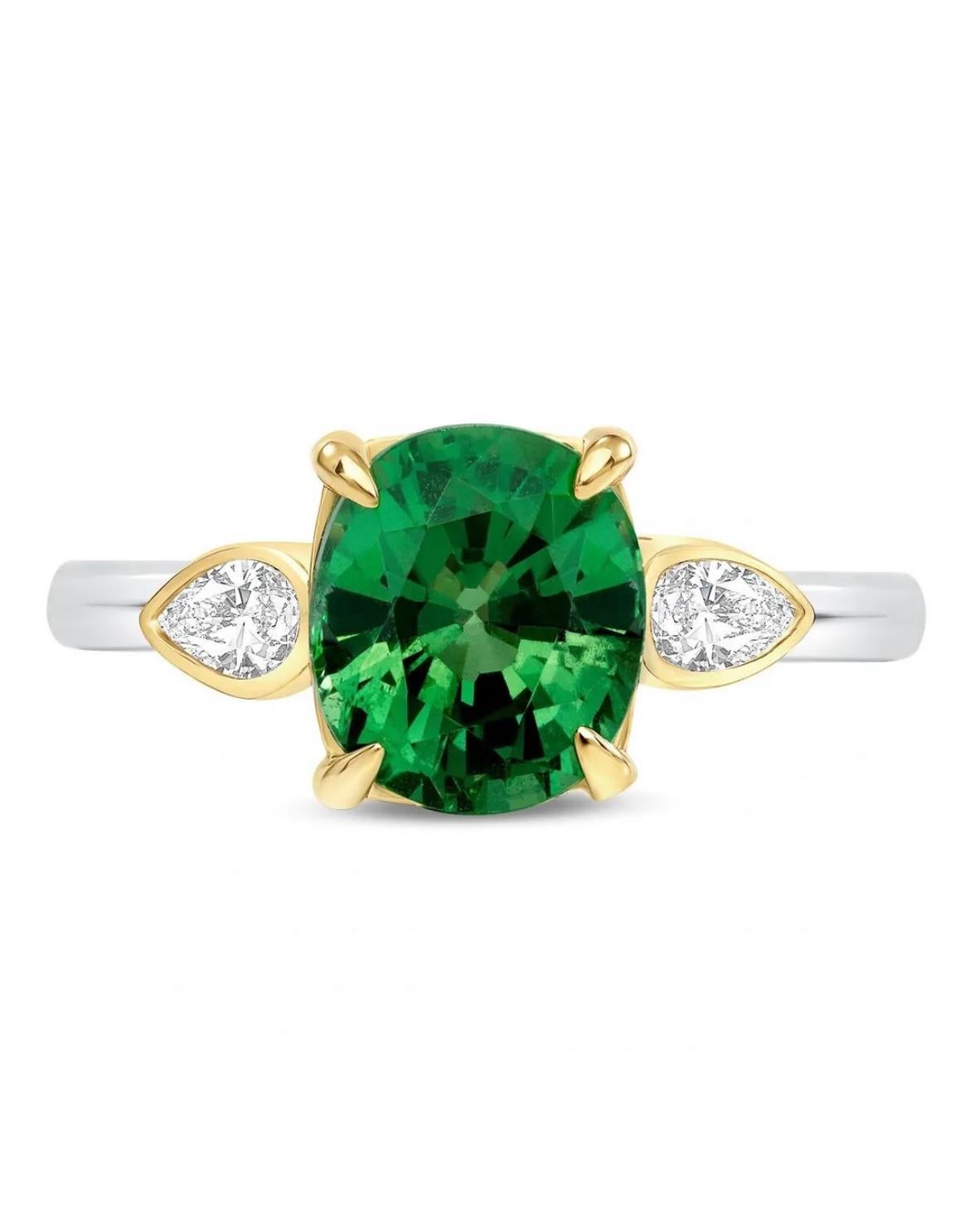 A delightful 2.64-carat, natural Tsavorite Garnet is flanked by two pear-shaped diamonds totaling 0.22 carats, fabricated in 18K. Tsavorite is GIA certified. 
