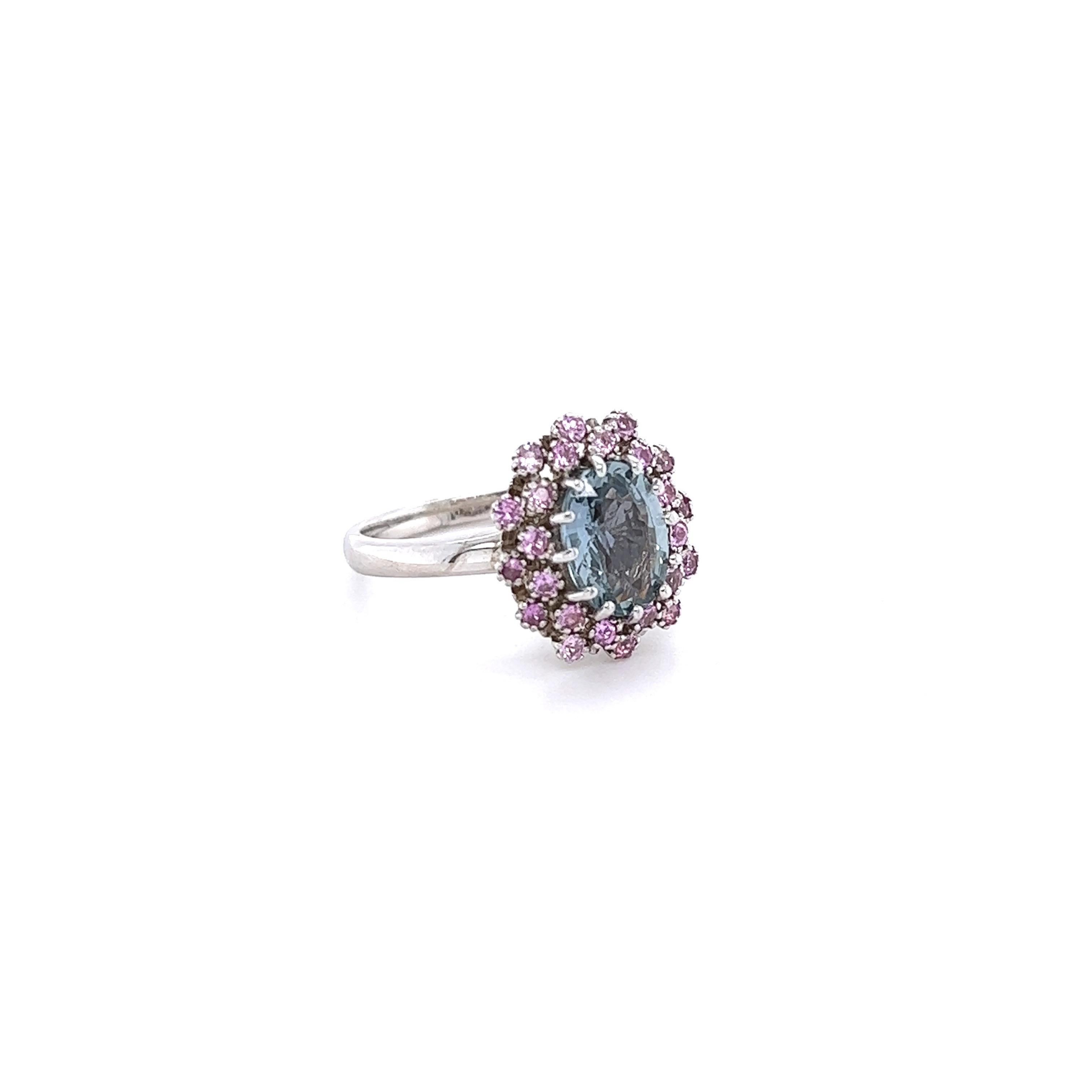 This ring has a Oval Cut Light Blue Sapphire that weighs 2.16 carats and measures at 9 mm x 7 mm. There are 24 Light Pink Sapphires that weigh 0.49 carats. The total carat weight of the ring is 2.65 carats. 

The ring is set in 14 Karat White Gold