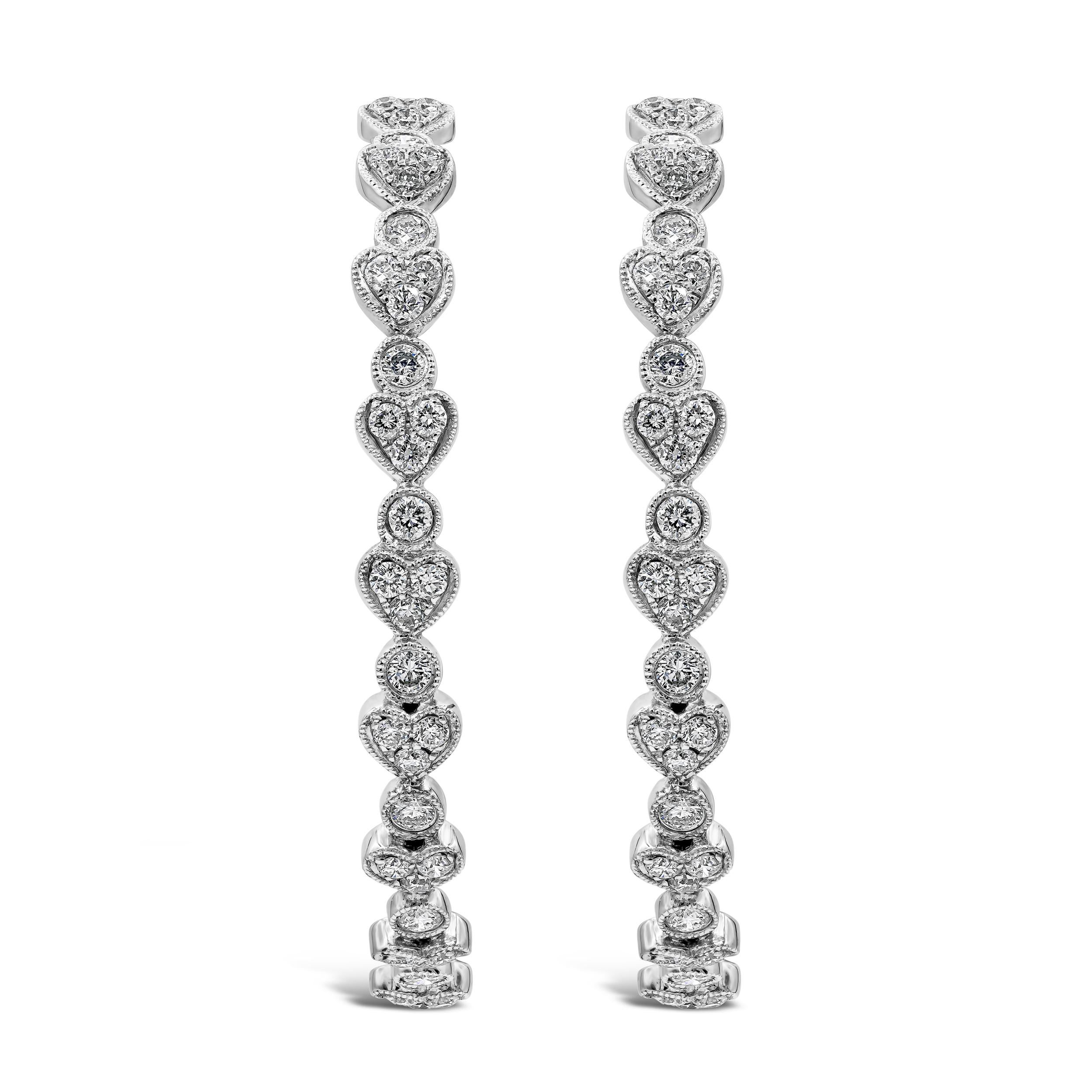 This trendsetting hoop earrings showcases a row of heart shapes set with round brilliant diamonds. Diamonds weigh 2.65 carats total. Made in 18 karat white gold. Good for everyday wear.

Roman Malakov is a custom house, specializing in creating
