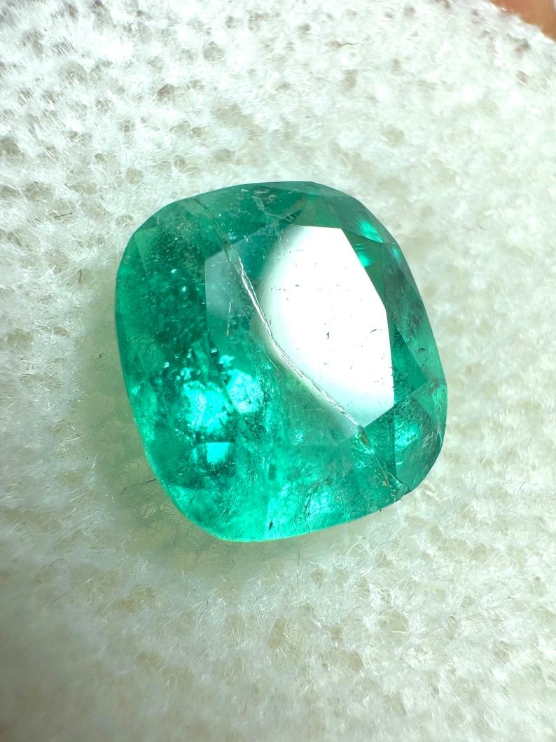 Stone: Emerald
Weight: 2.65-carats
Shape: Cushion Cut
Clarity: Transparent
Luster: Very Good
Color: Pastel Bluish Green
Measurements: 8.99mm x 8.07mm x 6.05mm
Geographic Origin: Colombia
Treatment: Natural, Oiling

Comments: Due to their growth