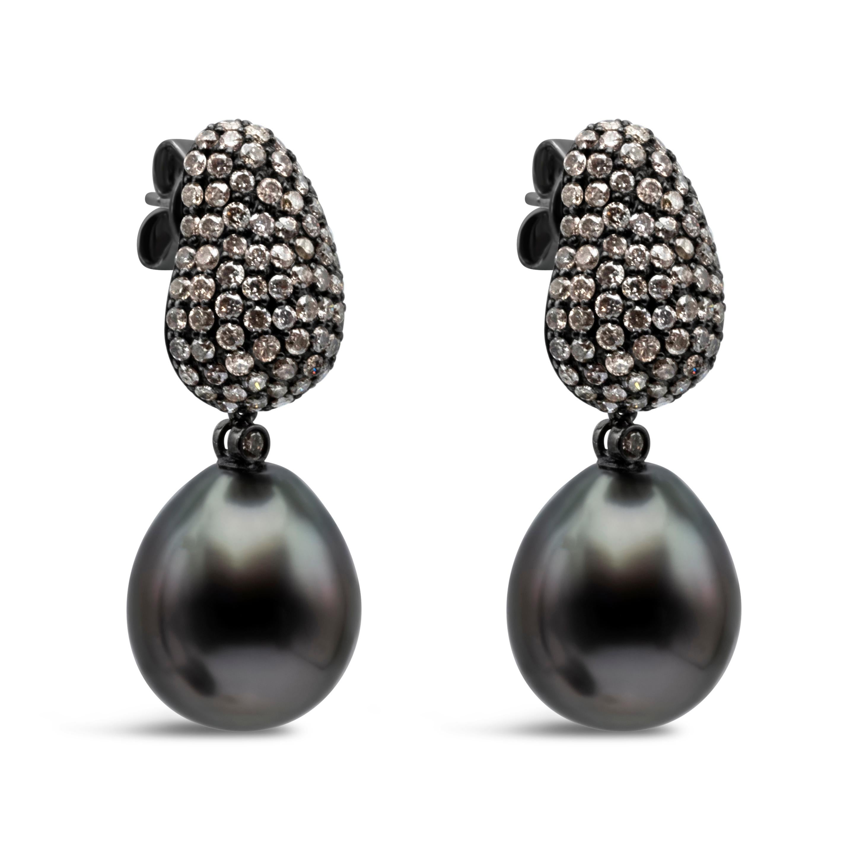 This elegant and stylish drop earrings feature 12-13 mm Tahitian Black pearls. This earrings has 184 round cut champagne diamonds weighing 2.65 carats total, pave set in a tear drop design. Pearl is suspended on a bezel set diamond. Made in 18K