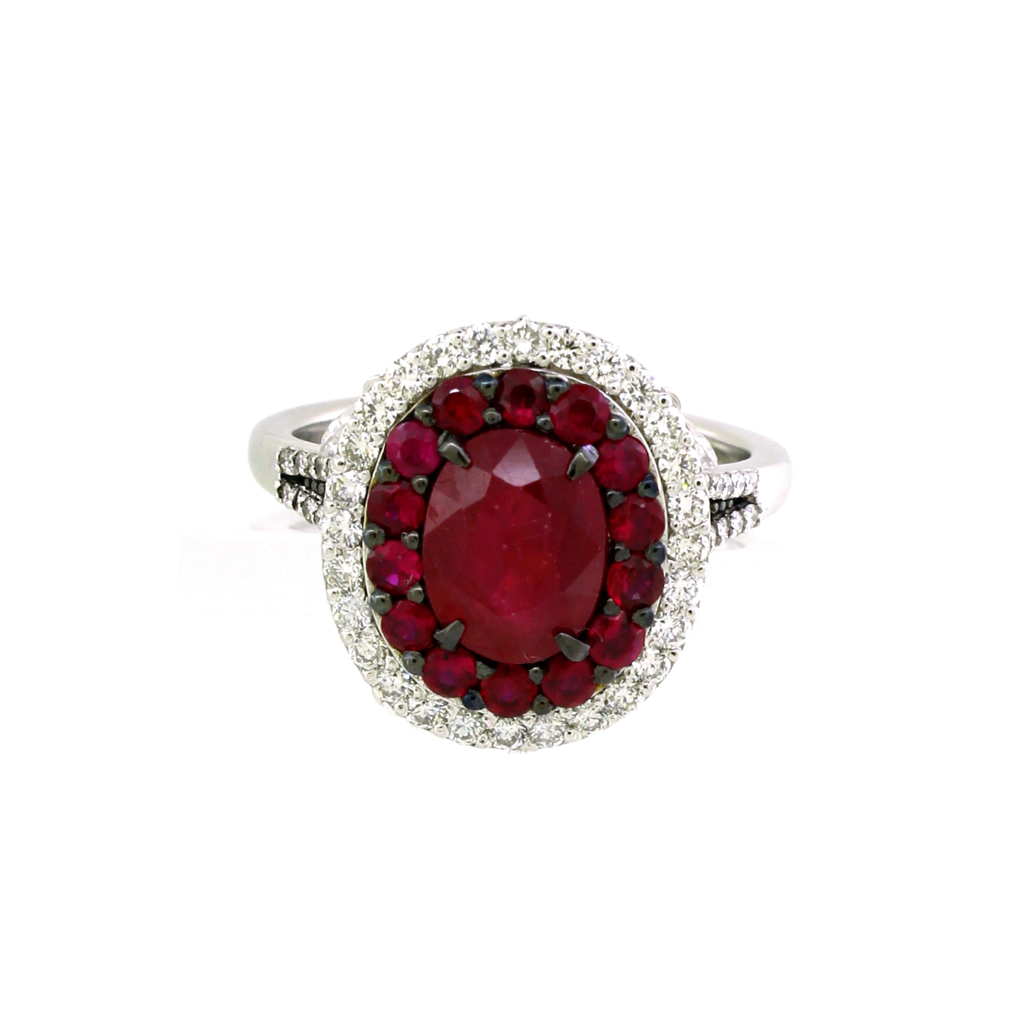 This stunning cocktail ring features a captivating 2.05-carat oval ruby at its center, radiating deep, rich red tones. Surrounding the ruby are two exquisite halos: the first halo consists of 22 small round rubies totaling 0.60 carats, enhancing the