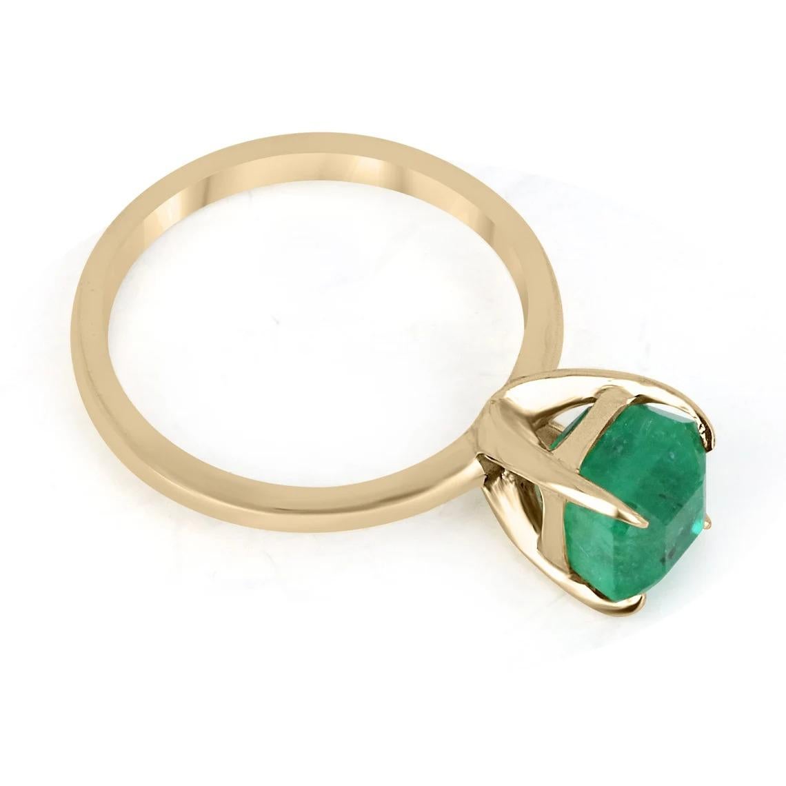 Displayed is a classic emerald solitaire Asscher-cut engagement ring/right-hand ring in 14K yellow gold. This gorgeous solitaire ring carries a full 2.65-carat emerald in a four-prong setting. Fully faceted, this gemstone showcases excellent shine.