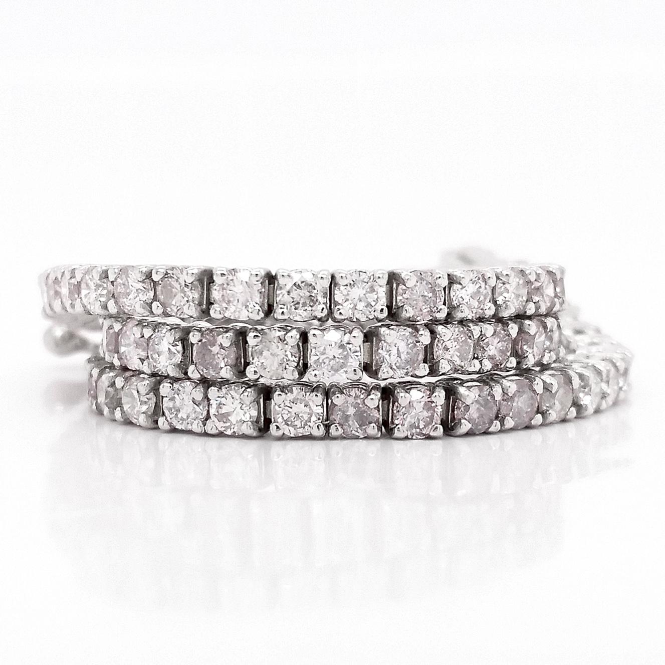 This amazing Tennis Bracelet showcases 79 faint pink - fancy purplish pink, 2.65-carat diamonds, set in 14kt white gold and giving the bracelet a uniquely sparkly and mesmerizing look. 
For more information, please check the attached