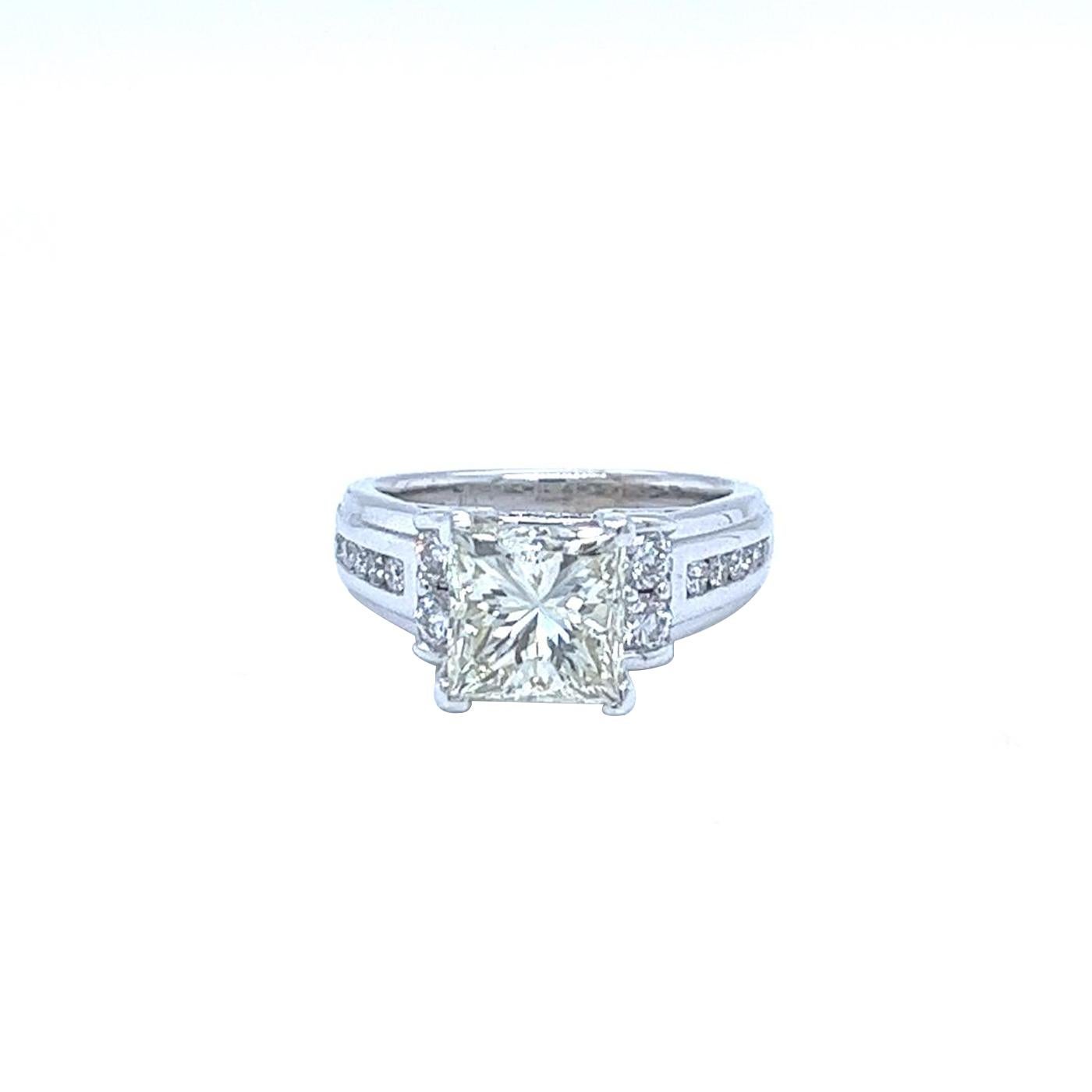 This dazzling 2.65 Natural Princess Cut Diamond Engagement Ring in 14k White Gold is a dream come true! Featuring M Color and VS2 Clarity with 0.35ct pave round diamonds H color and VS1 Clarity. The diamond is set in a classic four-prong, Bright