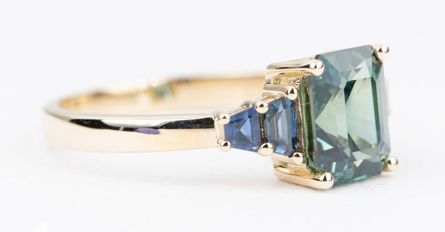 ♥  This is a stunning ring featuring a beautiful teal blue sapphire in the center, flanked by fancy shape blue sapphires on the side.
♥  The center stone has the most amazing mix of blue and green color! Very saturated color in this beautiful gem!