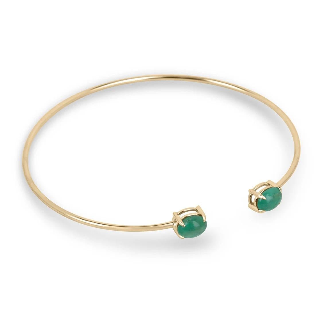 The toi et moi cuff bangle bracelet is a stunning piece of jewelry that symbolizes the intertwining of two individuals. This exquisite bracelet features two oval shaped cabochon emeralds, weighing a total of 2.65 carats, set in a four-claw prong