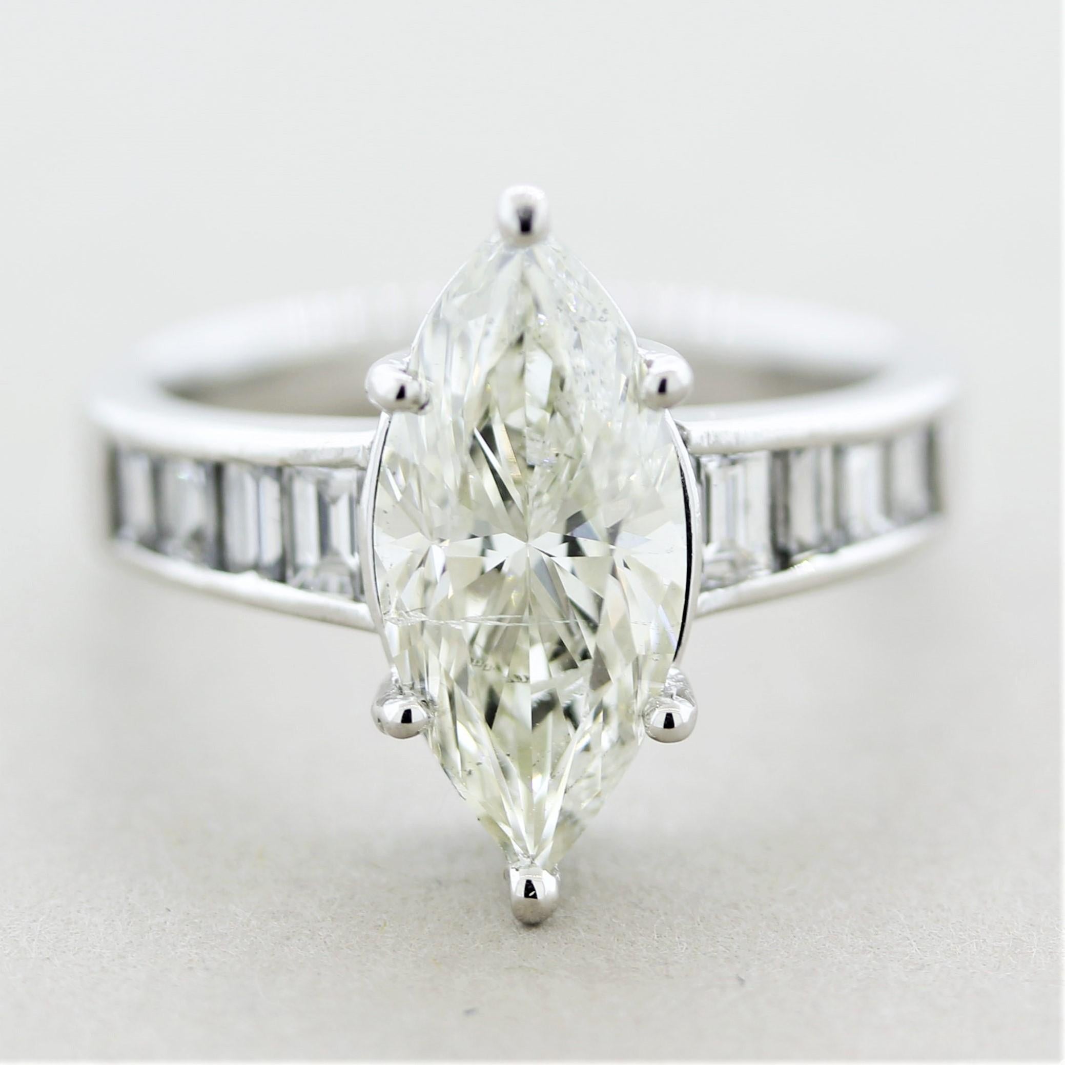 A lovely engagement ring featuring a 2.66 carat marquise-shape diamond! It has a long beautiful shape making it look like a 3 carat stone. It has a color of J-K and clarity grade of SI2. It is accented by 0.77 carats of baguette-cut diamonds which