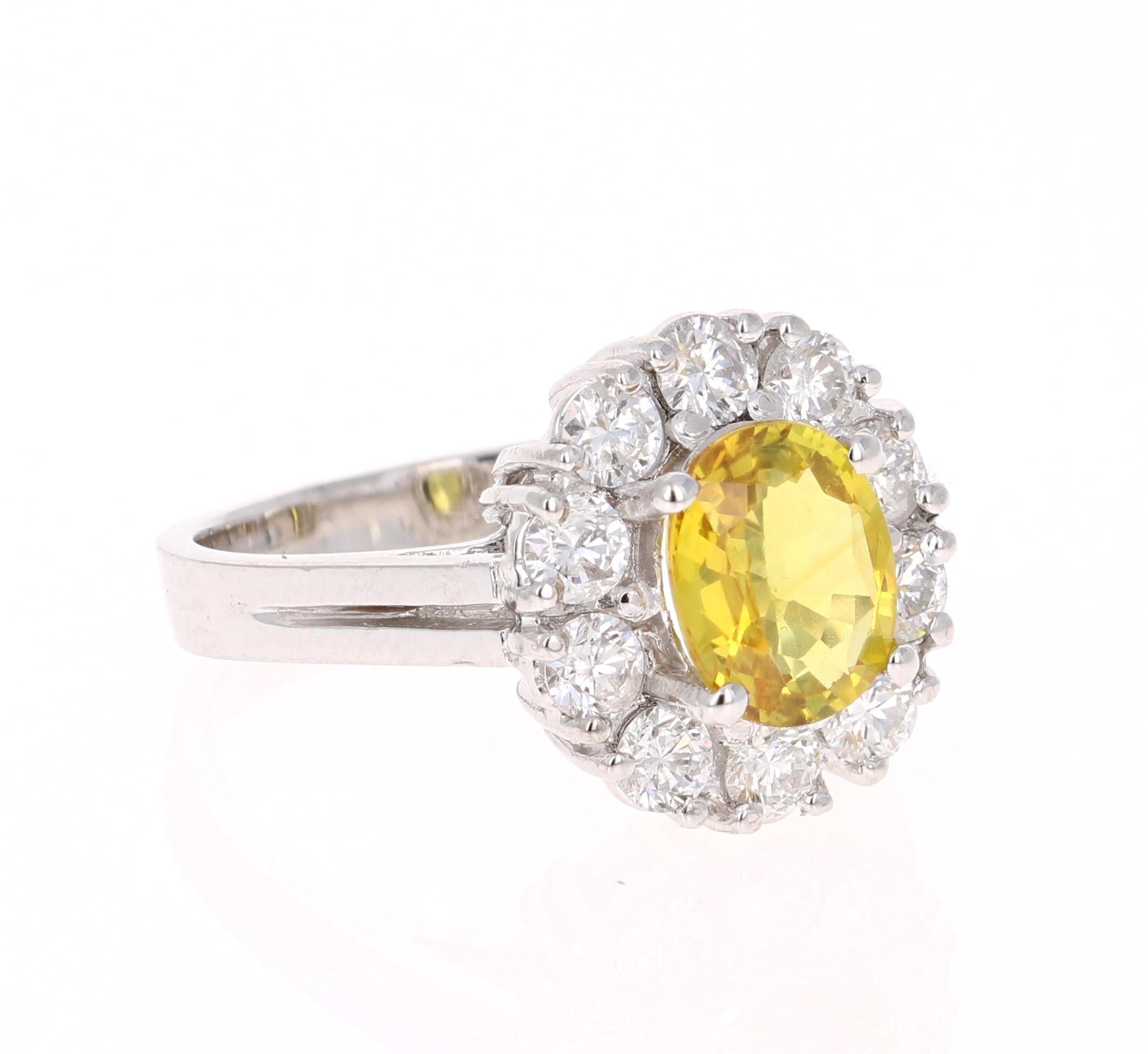 A gorgeous Yellow Sapphire Ring in a classic ballerina setting! This gorgeous Yellow Sapphire is a natural, Oval Cut Sapphire that weighs 1.69 carats. 
It has a halo of 10 Round Cut Diamonds that weigh 0.97 carats (Clarity: SI, Color: F). 
The total