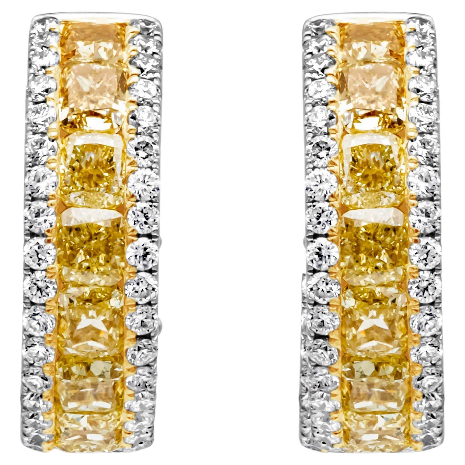Each beautiful half-way hoop earring features a row of cushion cut fancy yellow diamonds weighing 2.66 carats total and VS in clarity, channel set in a round diamond encrusted white gold mounting weighing 0.62 carats total, F color and VS in