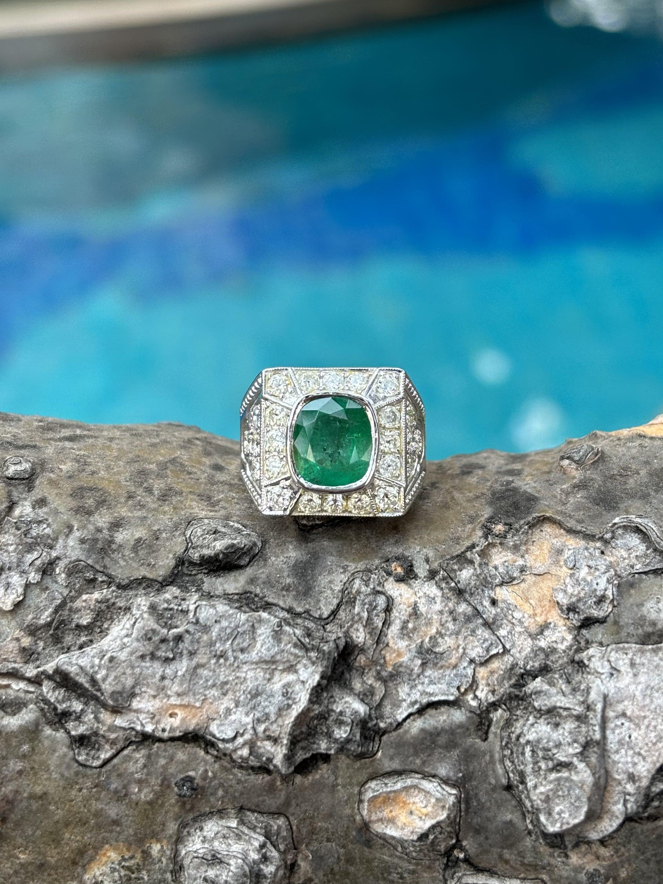 Introducing the epitome of luxury and sophistication, behold the breathtaking Art Deco inspired, Emerald Statement Ring, a true marvel in the world of fine jewelry. Crafted with precision and passion, this extravagant piece exudes opulence from