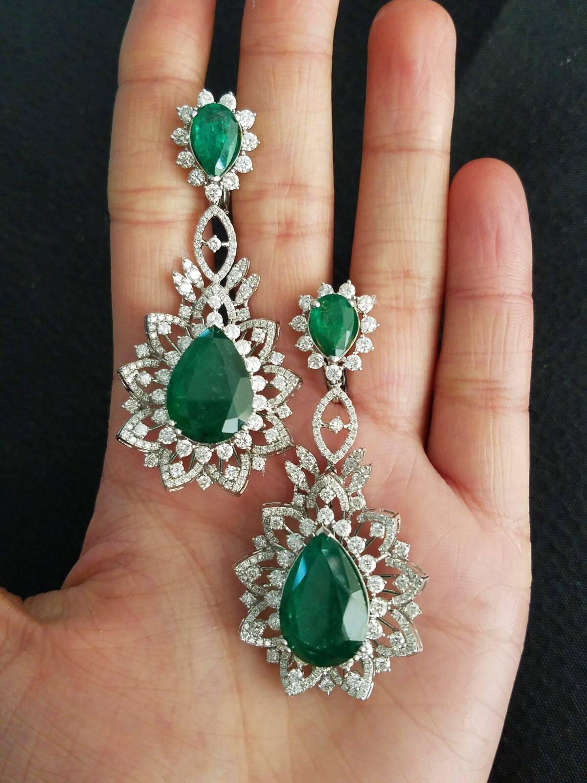 A statement pair of 26.64 carats Zambian Emerald pear shape earrings, of great quality and colour set in 18K White Gold with White Diamonds. 

Stone Detail:
Stone: Zambian Emerald 
Total Weight: 26.64 carat

Diamond Detail:
Total Weight: 6.68