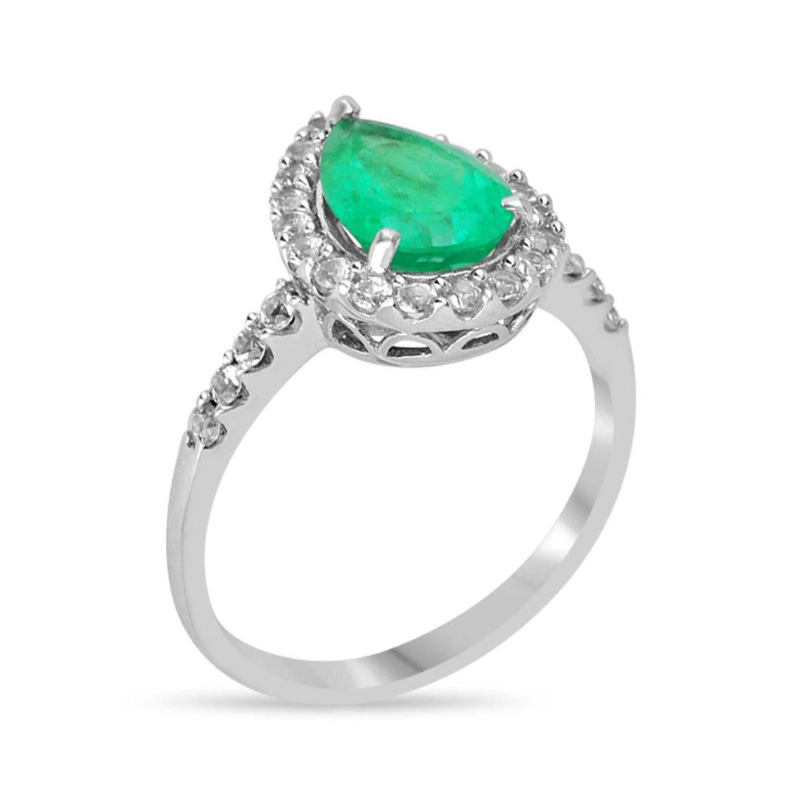 Elevate your proposal with our stunning Earth Mined Emerald and Diamond Engagement Ring, showcasing a mesmerizing pear-cut rare Zambian emerald at its heart, radiating with vivid medium dark green hues and semi-transparent clarity, reminiscent of