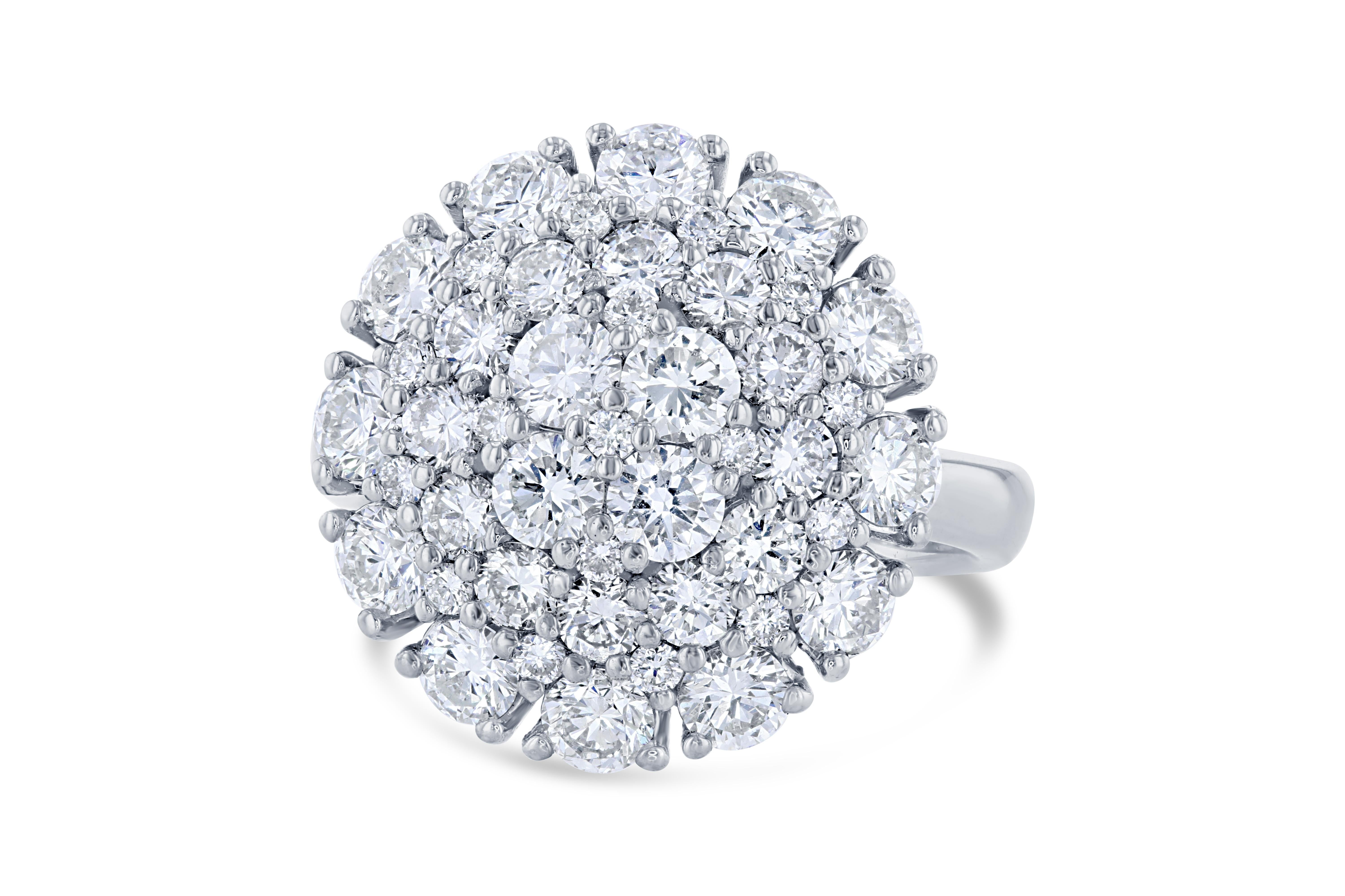 This cocktail ring has 45 Round Cut Brilliant Diamonds that weigh 2.67 Carats. The Clarity and Color of the Diamonds are VS-F. 

It is beautifully set in 14 Karat White Gold and weighs approximately 5.7 grams

The ring is a size 6 1/2 and can be