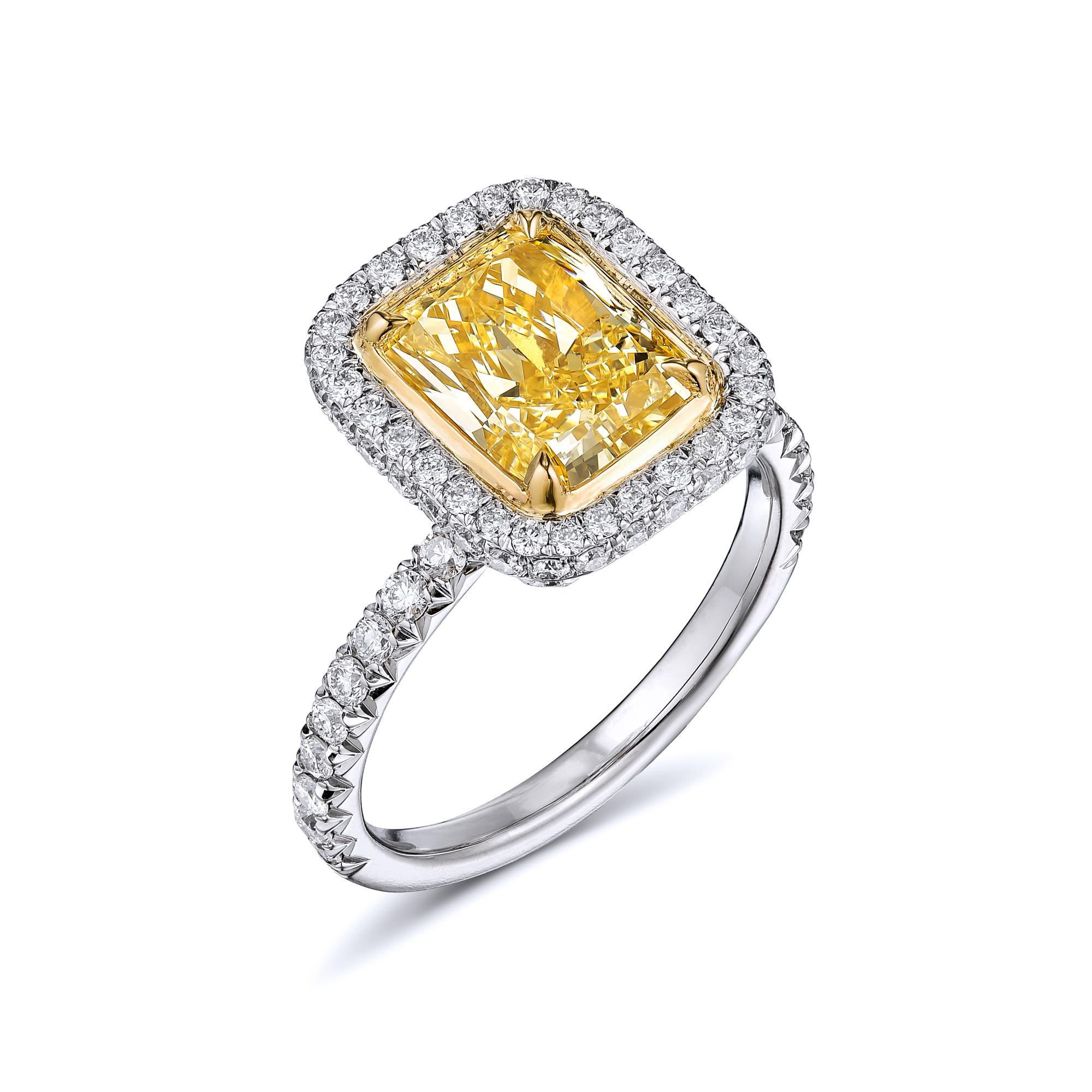 Fancy Yellow Diamond ring. Center stone: 2.55ct/ SI2 radiant cut fancy light yellow diamond. Side stones: 1.08ct /F-G VS2-SI1 Brilliant round diamonds. Total carat weight =3.63ct. Metal: Platinum, 18K yellow gold. Ring weight 6.6 grams. Ring size 5