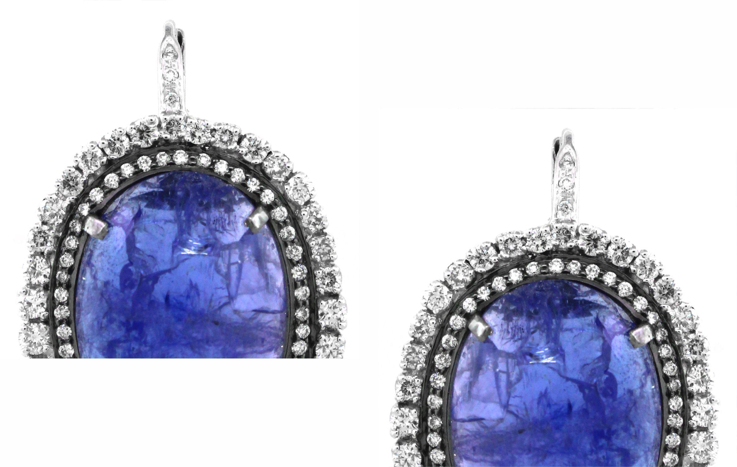 Introducing our exquisite Vintage Tanzanite Drop Earrings, meticulously crafted in luxurious 18K white gold, weighing a total of 15.09 grams. These captivating earrings feature a mesmerizing centerpiece of Tanzanite gemstones, each boasting an