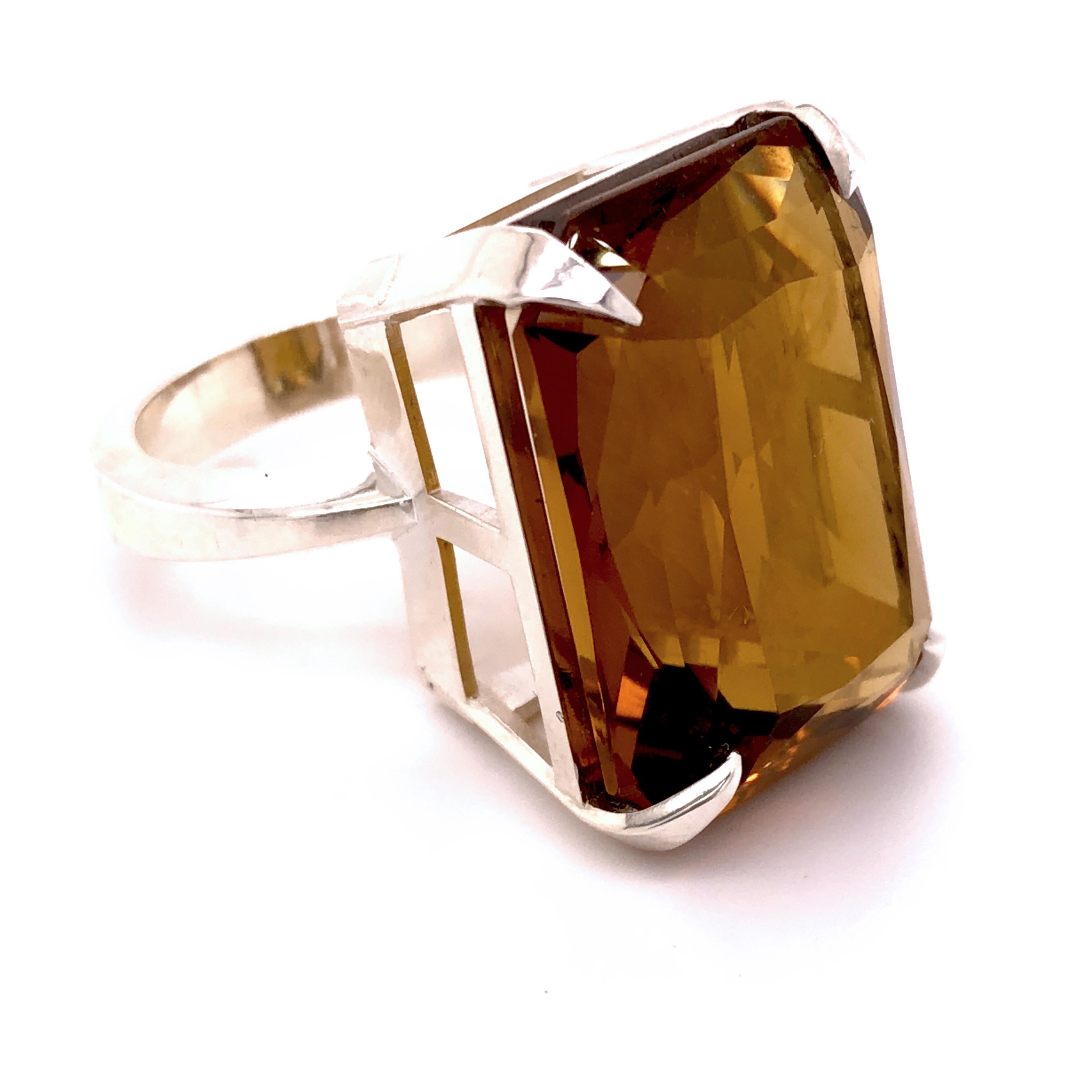One-of-a-kind 26.78 Carat Emerald Cut Natural Smoky Quartz(0.90inches lenght 0.677inches width, 23x17.2mm) in a Chic yet Timeless mirror Finish Sterling Silver Cocktail Setting.
We are proud to offer this awesome piece perfect as Engagement Ring as