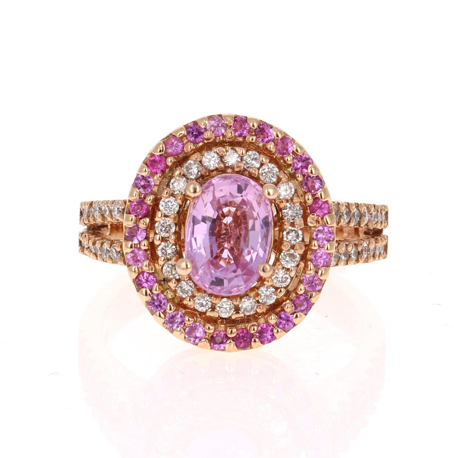 Breathtaking Pink Sapphire Diamond Ring with a beautiful split shank setting! Can be the most unique Engagement or Cocktail Ring! 

The center Oval Cut Pink Sapphire is 1.90 Carats and is surrounded by a double halo. One of the halos has 48 Round