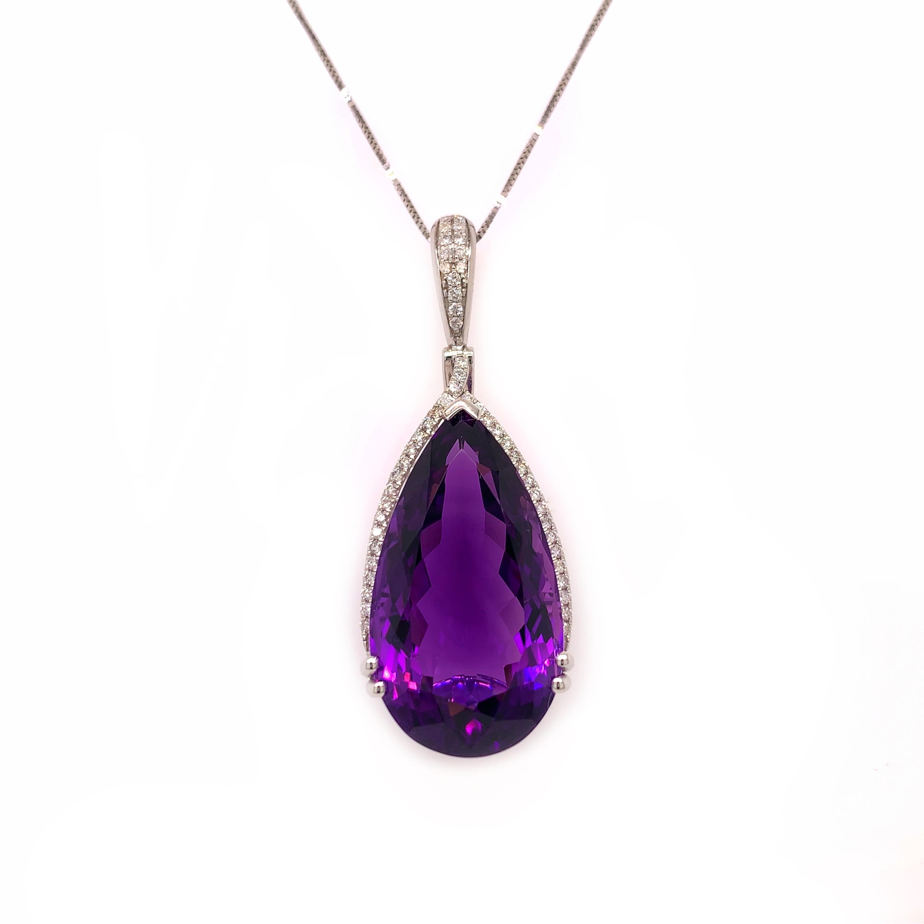 Glamorous large amethyst pendant. High brilliance, transparent clean, pear shape faceted, with a checkered cut pattern, rich eggplant purple tone, natural 26.82 carats amethyst mounted in an open basket profile with four bead prongs and knife prong,