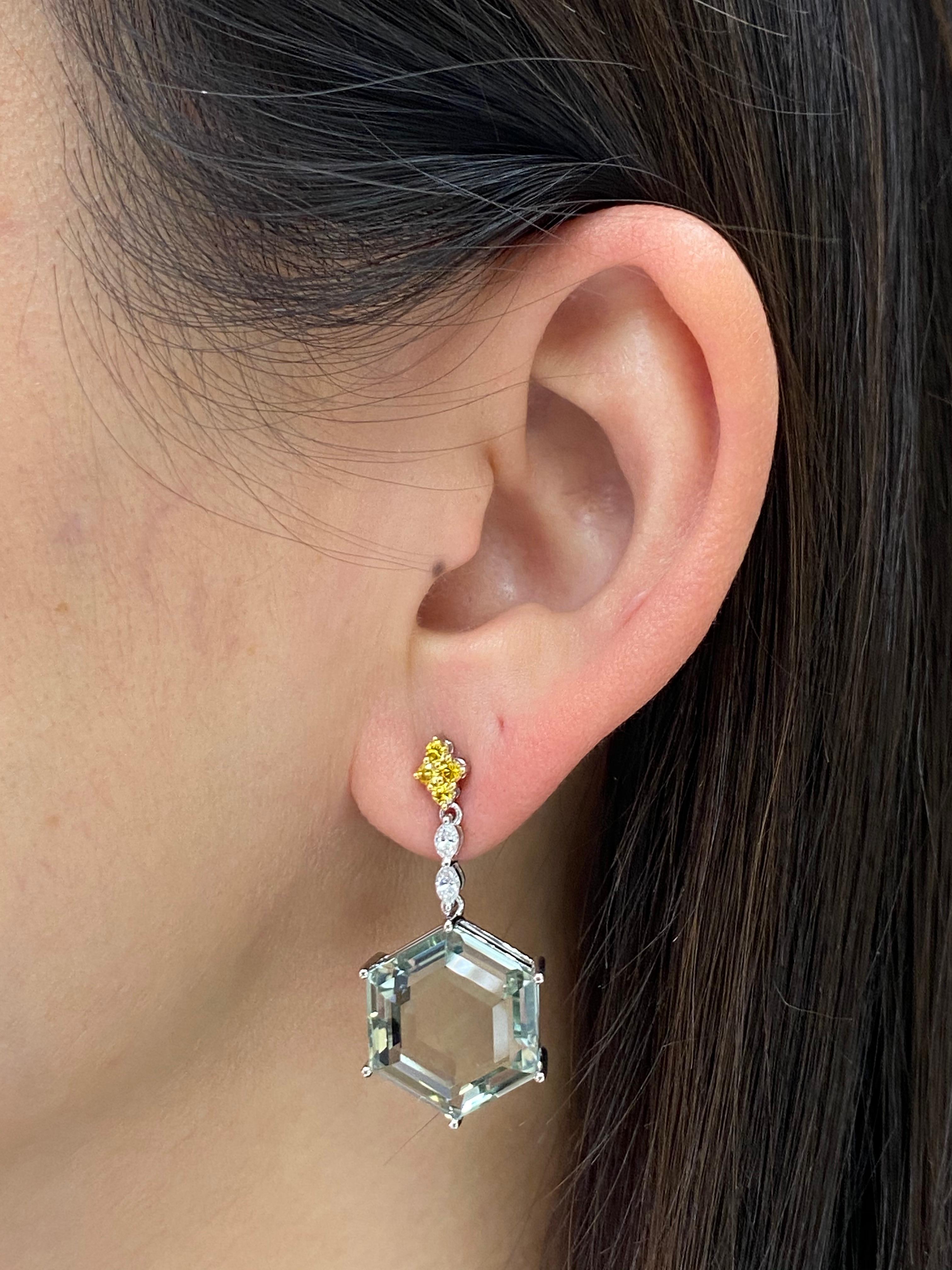 This is a statement piece! Here is a very special pair of drop earrings. The design is superb. The earrings are set in 18k white gold, Starting form the top are 0.30 cts of fancy vivid yellow diamonds followed by 0.28 cts of marquis diamonds. At the