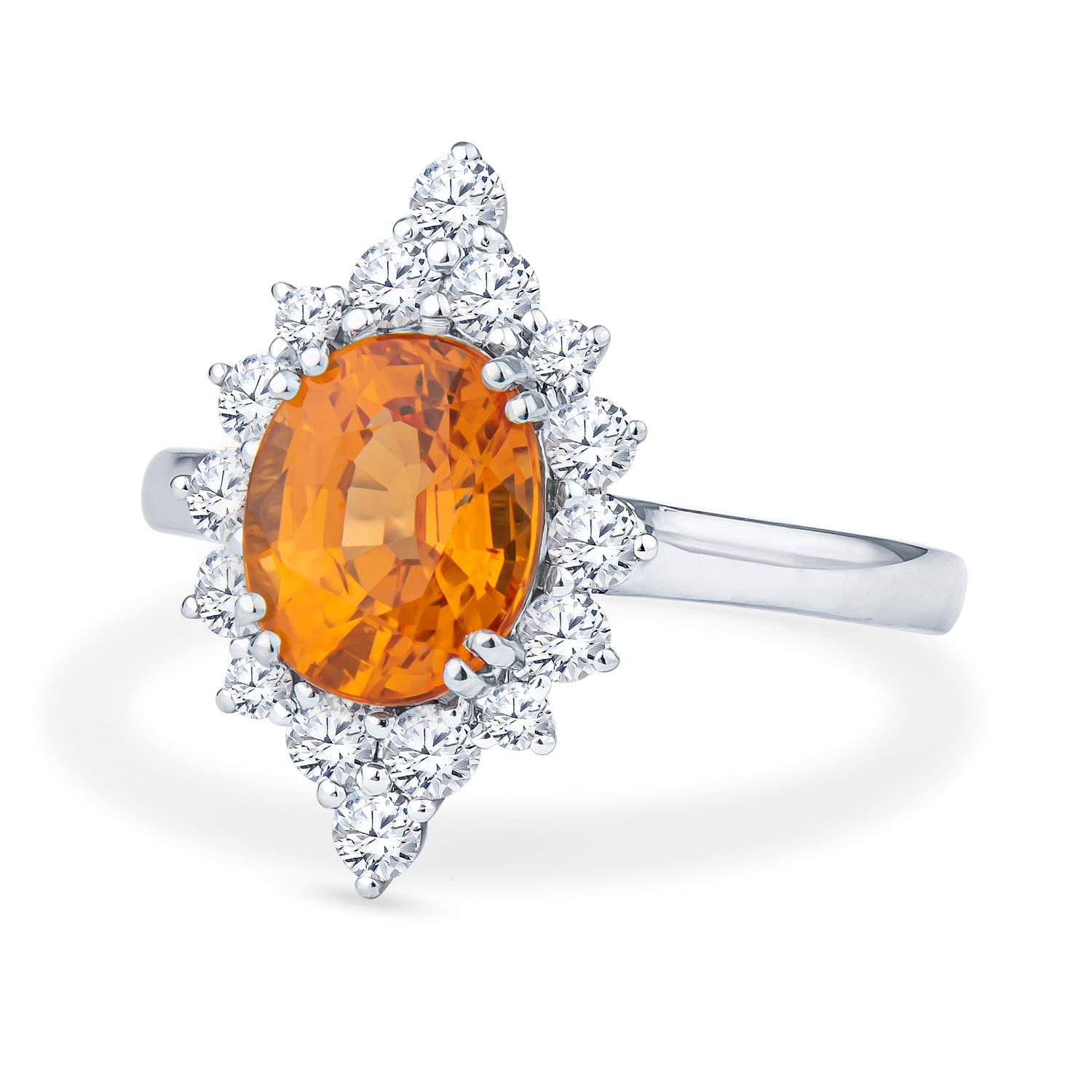 This eye-catching 2.68ct natural oval Spessartine Garnet is a bold orange shade, sure to be noticed by everyone. This ring is complemented with several natural round diamonds surrounding it, weighing a total of 0.55 carats. The stones are set in a